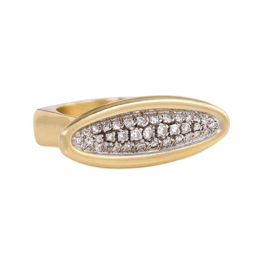 A sculptural gold and pavé diamond ring of oblong design with angled band, in 18k. Cartier, #019975.

Oblong panel measures approximately 2cm across
Current size: 7 1/2 (Minor re-sizing is possible; please contact us for assistance.)
In pristine