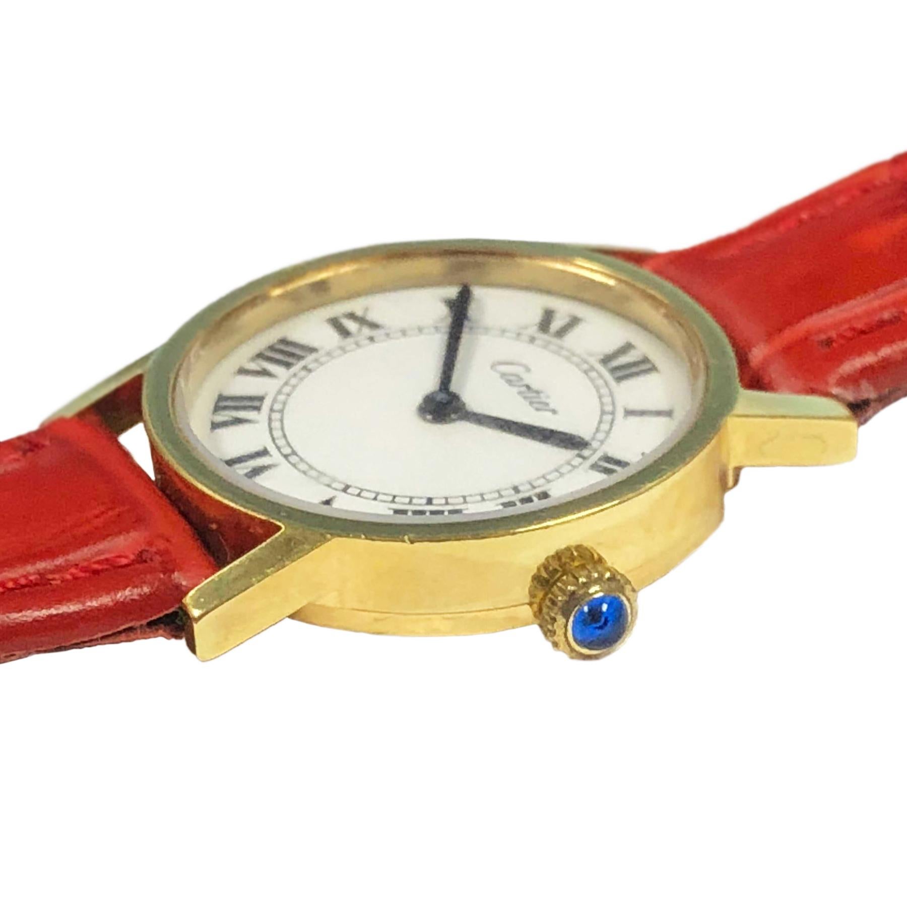Circa 1970s Cartier Ladies Wrist Watch, 24 MM 2 piece Gold Plate Case, 17 Jewel Cartier Inc. Mechanical, Manual wind movement. White Dial with Black Roman Numerals, Sapphire set crown. New Hadley Roma Red Textured strap with Cartier gold Plate Tang