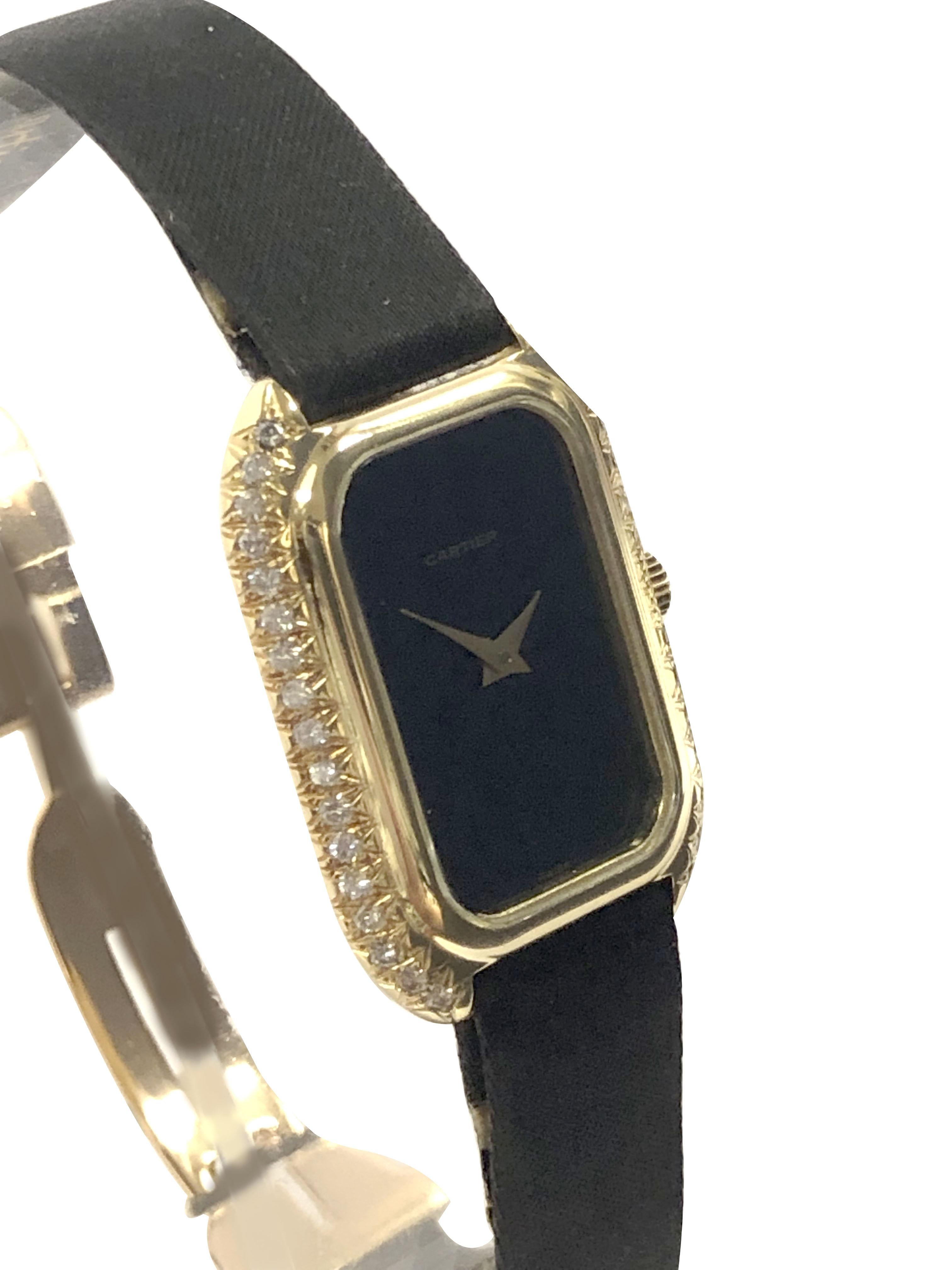 Circa 1970s Cartier Ladies Wrist Watch, 30 X 21 M.M. 18k Yellow Gold 2 piece case with Cartier Factory set Round Brilliant cut diamonds totaling .40 Carat. Cartier Inc. 17 Jewel Nickle Lever, Mechanical, Manual wind movement.Black Dial with Gold
