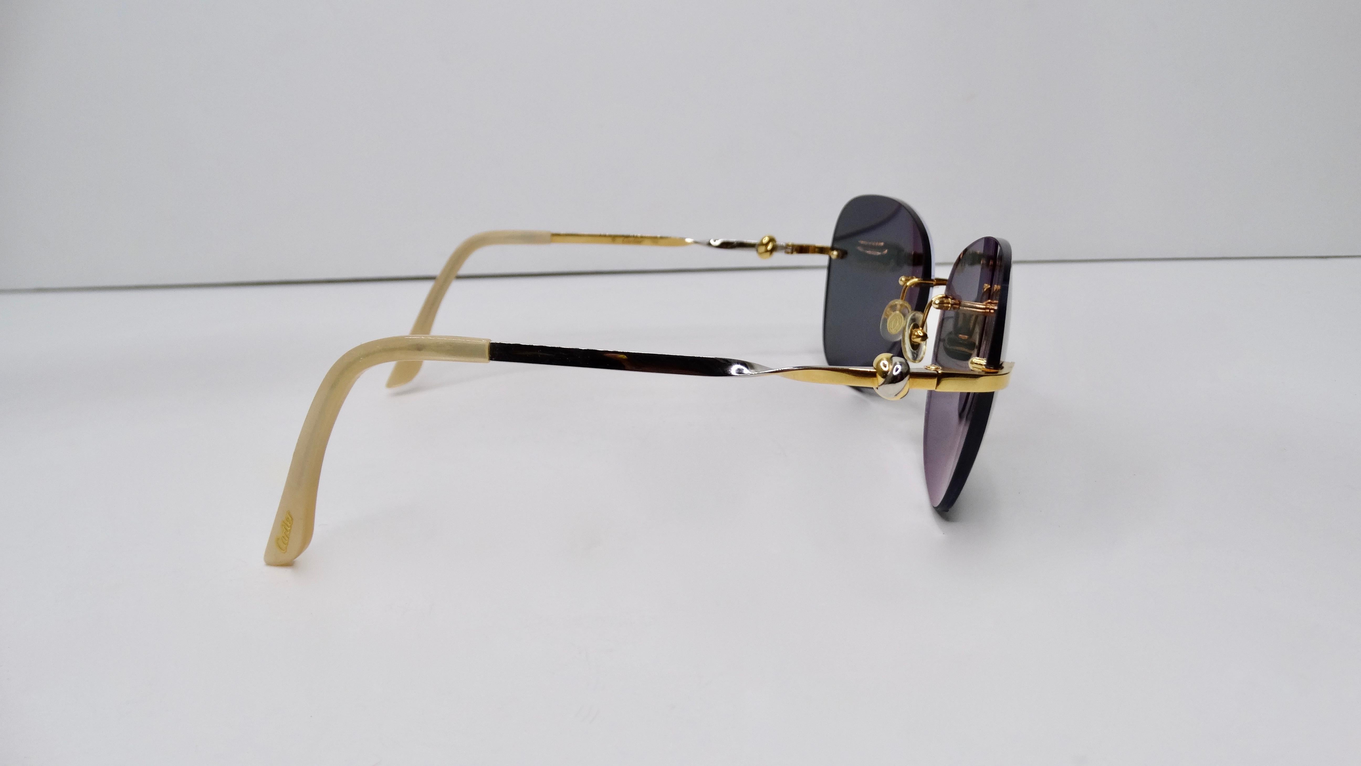 A favorite of both jewelry and fashion lovers, Cartier is always a classic! Circa 1980s, these rimless sunglasses feature a two-tone silver and 18k gold plated frame with a twisted/knotted design. The lenses in these sunglasses are prescription and