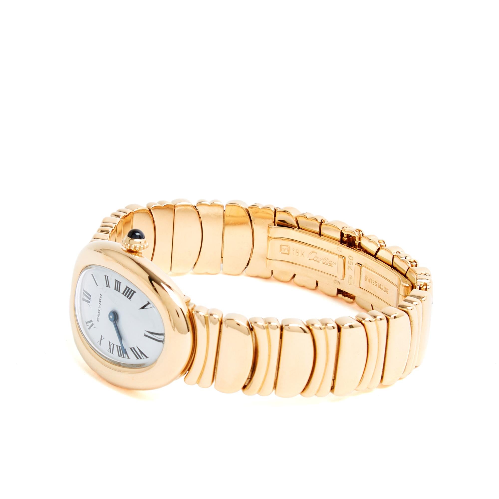 Cartier watch circa 1990 Baignoire model in yellow gold, oval case (legendary), white dial with Roman numerals, quartz movement, blued steel hands, winding mechanism or crown decorated with a blue cabochon, yellow gold bracelet called 