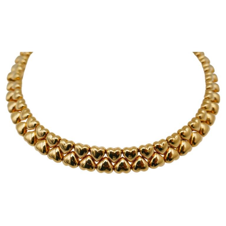 A gorgeous glossy heart shaped collar necklace by Carteir, circa 1994. Made of 18k yellow gold. Stamped with Cartier maker's mark, a hallmark for 18k gold, a year of production and a serial number. 
Measurements: 1/2