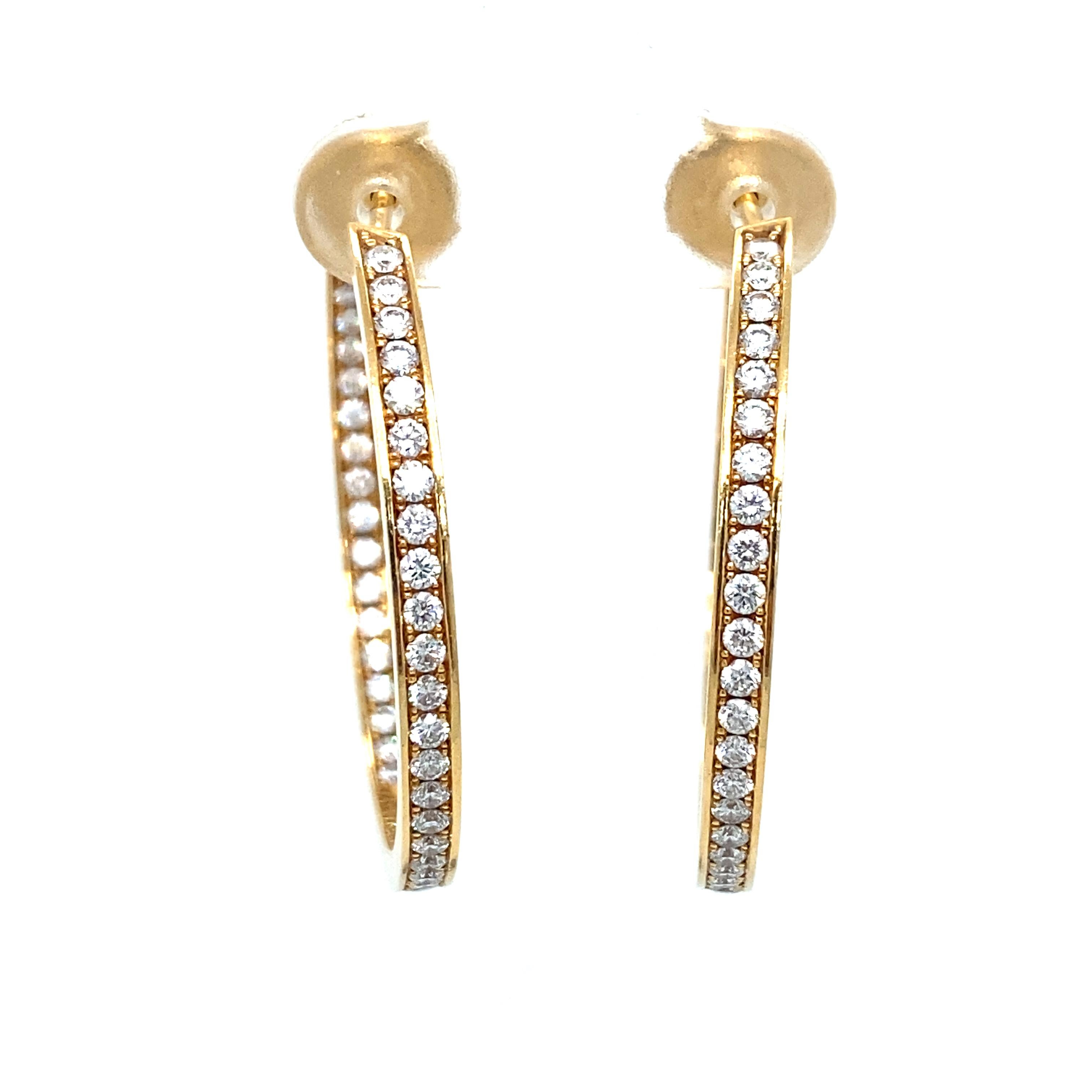Item Details: These spectacular diamond earrings by CARTIER feature two carats of round diamonds in an inside-out setting crafted of 18 karat yellow gold. They are fitted with secure backs and are also marked with the CARTIER maker's stamp. These