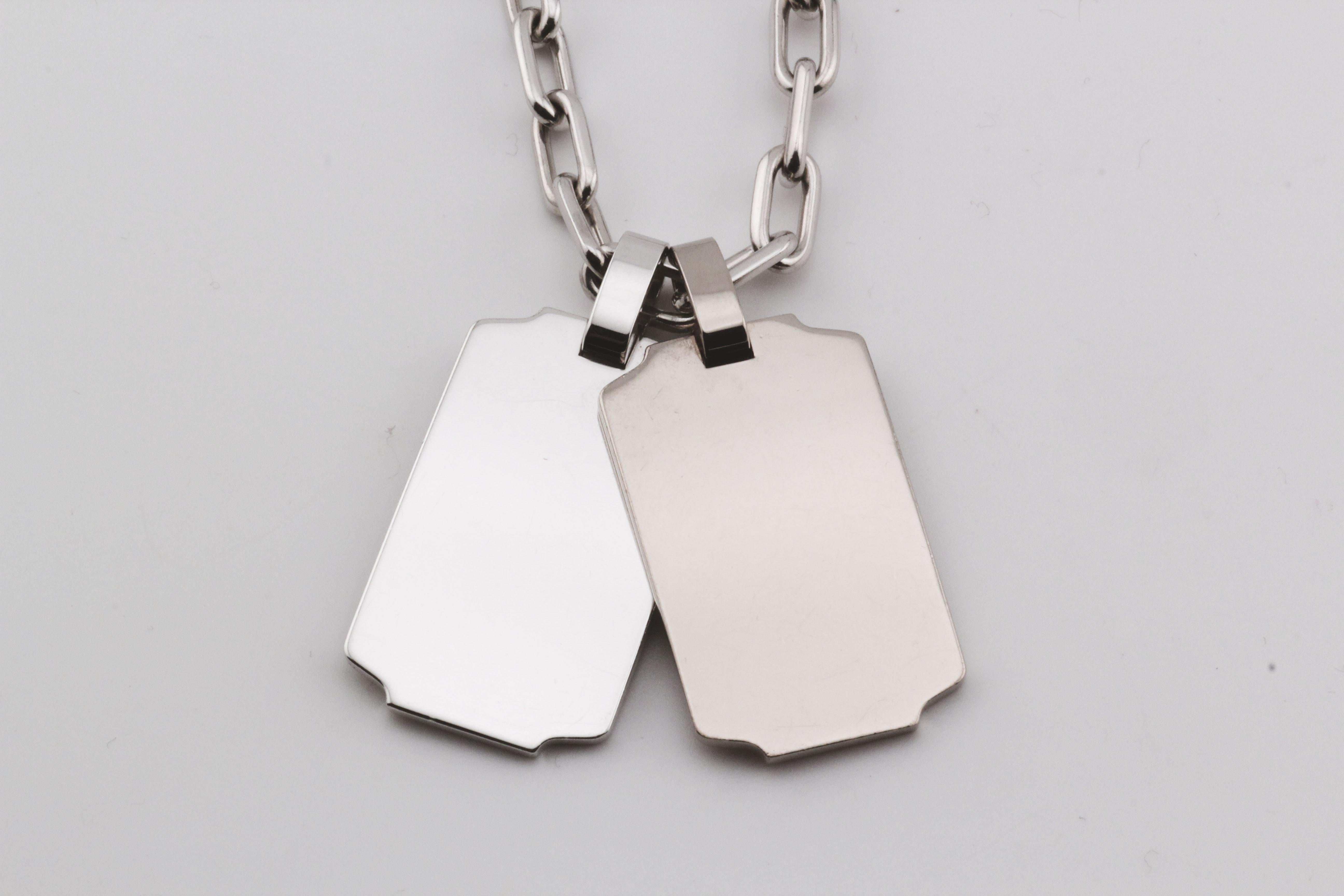 Embrace versatile luxury with the Cartier Spartacus Dog Tag Bracelet & Necklace Combo, a bold statement piece that seamlessly transitions between modern sophistication and edgy style. Crafted from radiant 18K white gold, this unique design