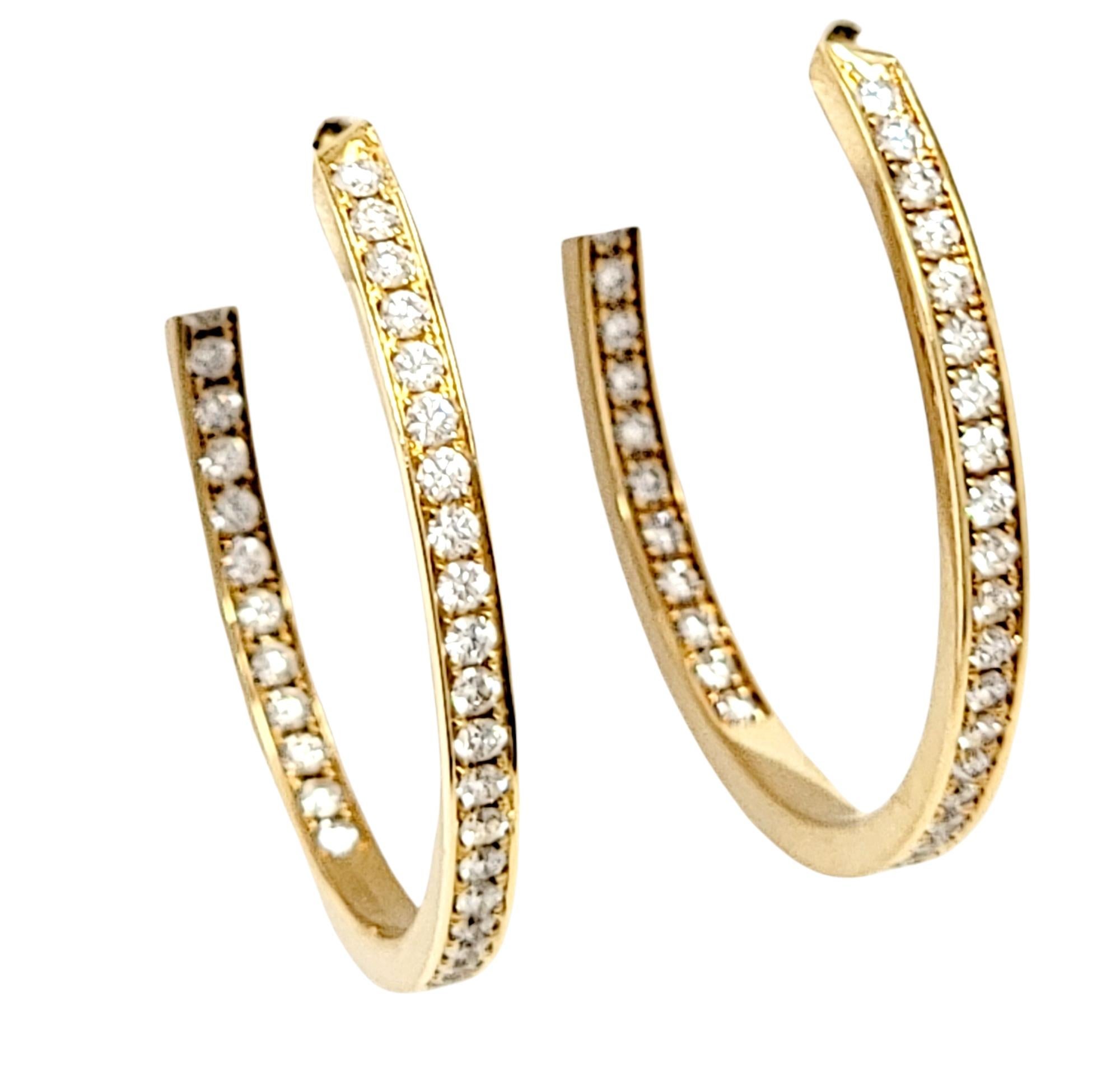 Absolutely gorgeous pave diamond hoop earrings by renowned jeweler, Cartier. The impressive pair are arranged in a stunning inside/outside setting, so the diamonds are positioned to catch the light from all angles. Hanging just under 1.5 inches