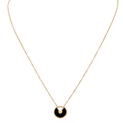 Collana contemporanea "Amulette de Cartier" di Cartier del 2000, in oro 18 carati con diamanti e onice