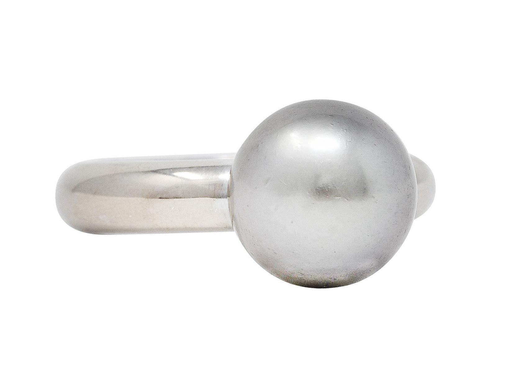 Ring designed as a sleek curved band with single pearl

Pearl is 10.0 mm round - Tahitian South Sea in origin 

Dark grey in body color with strong rosè overtones and very good luster

Stamped 750 for 18 karat white gold 

Fully signed Cartier