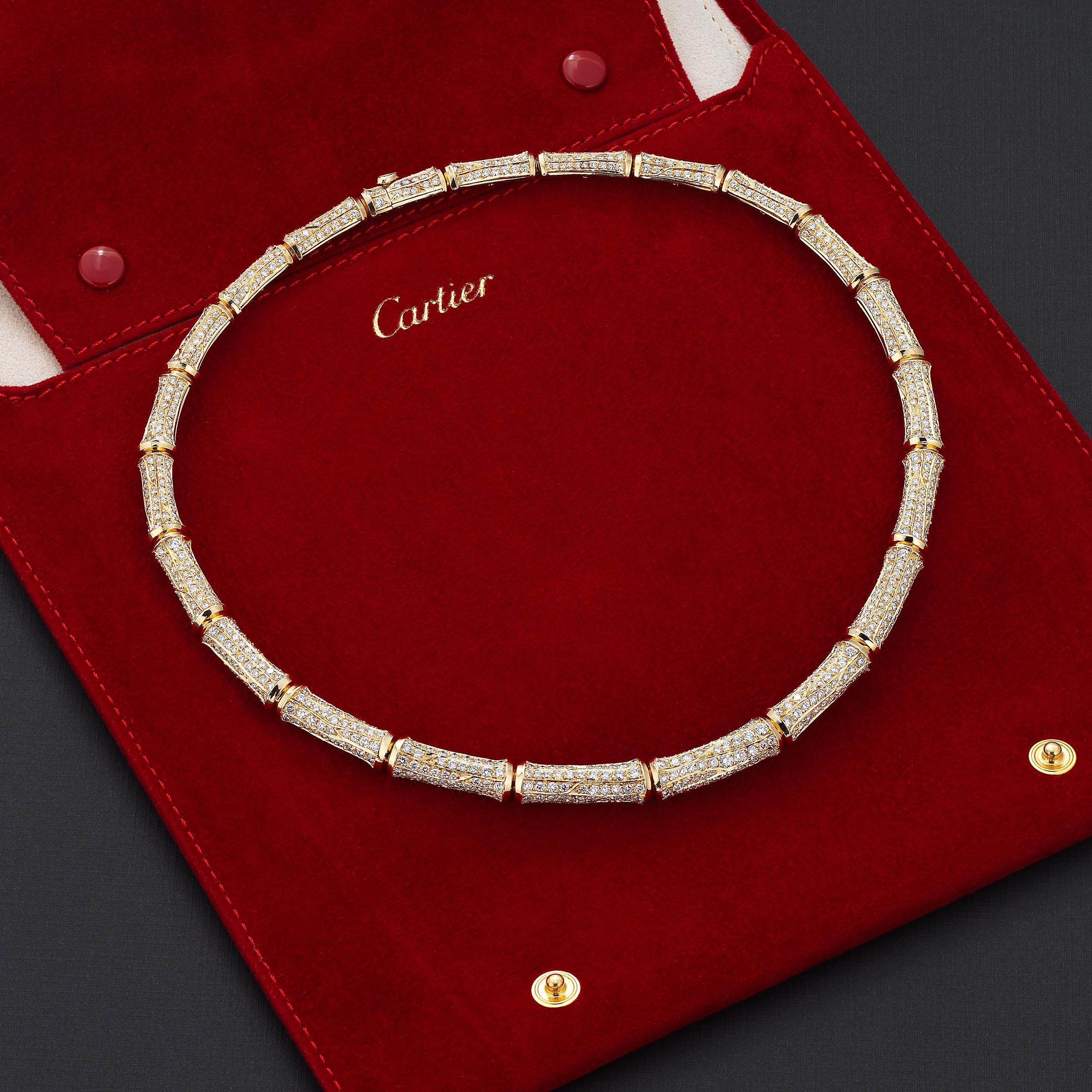 Dazzling vintage Cartier Bamboo necklace showcasing approximately 20 carats of fine-white brilliant round diamonds impeccably set in lustrous 18 karat yellow gold. The necklace rests effortlessly and comfortably on the collar, allowing for full