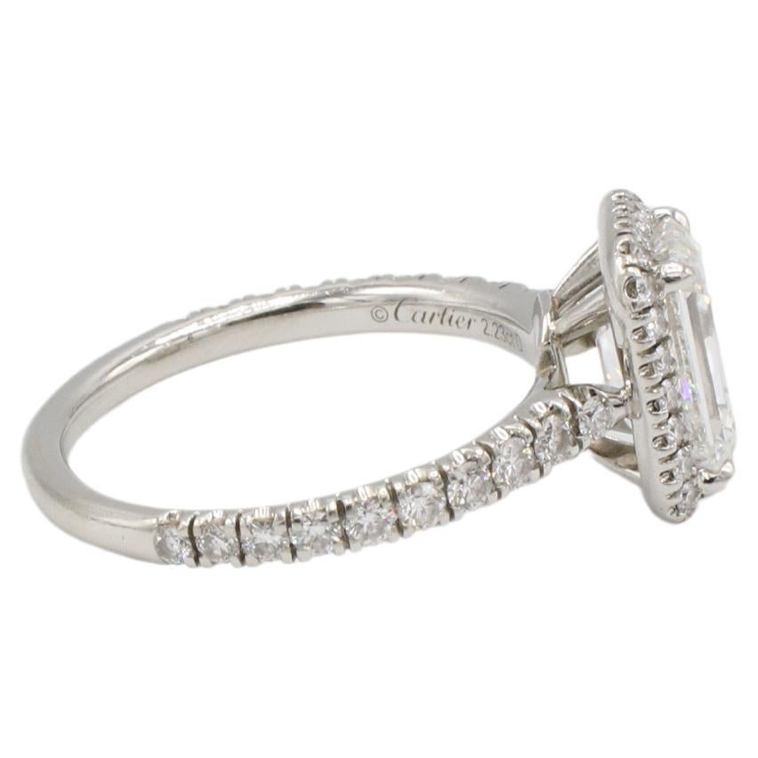 Cartier 2.23 F VVS2 Emerald Cut Natural Diamond Halo Platinum Engagement Ring 
GIA Report Number 2195208633
Diamond: 2.23 carat F VVS2 emerald cut natural diamond
Accent diamonds: Approx. 0.65 CTW E-F VVS round natural diamonds
Metal: 
