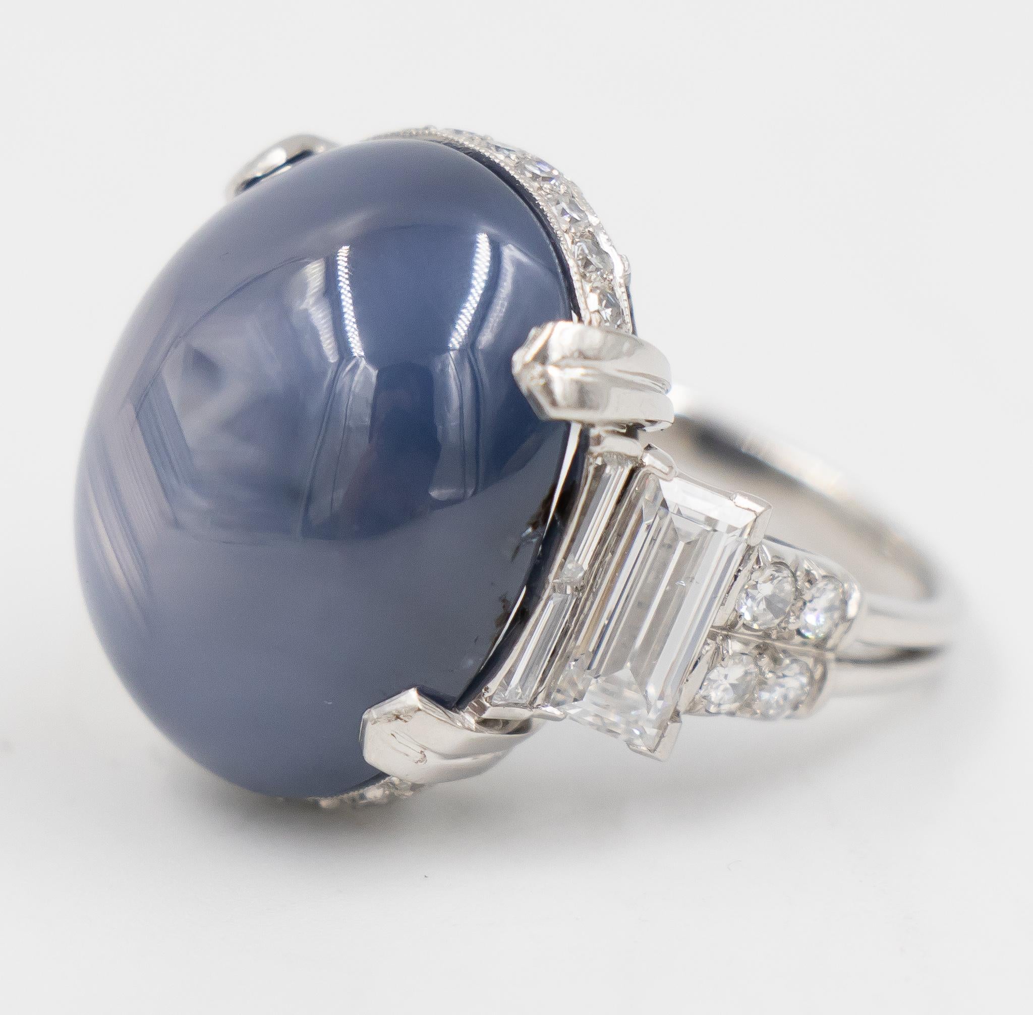 Back in 1935 this ring was created for Cartier by famous jewelry designer, Oscar Heyman.  This design has been created in platinum with custom baguette diamonds and round brilliant diamonds accenting the sapphire.  The star sapphire has a beautiful