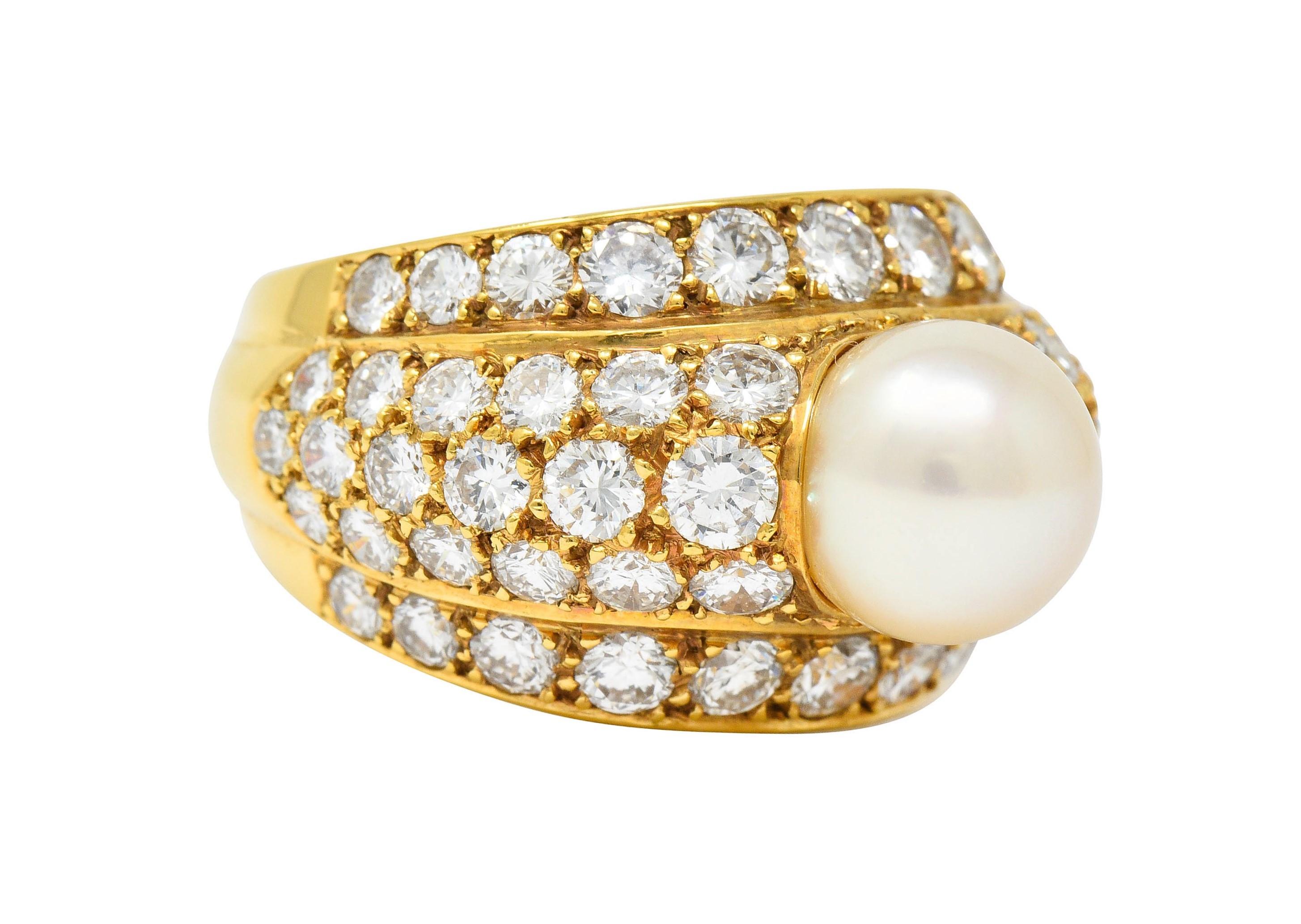 Band ring centers an 8.1 mm round cultured pearl, cream in body color, with rosé overtones and excellent luster

Surrounded by rows of pavé set round brilliant cut diamonds weighing in total approximately 2.80 carats; G/H color with VS