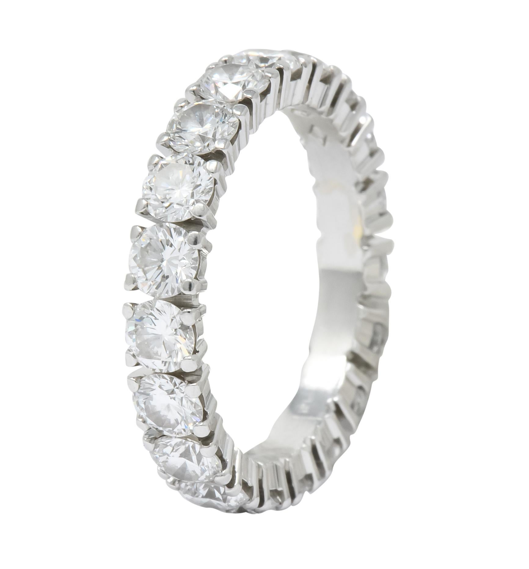 Eternity style band prong set throughout with round brilliant cut diamonds

Weighing 3.05 carats total with G//H color with VS clarity (one diamond is SI)

Fully signed Cartier and numbered with Switzerland assay marks for Platinum

Stamped 54 for
