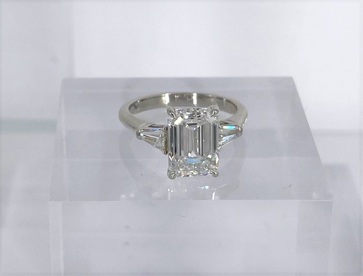 Timeless and chic, this emerald cut diamond engagement ring by Cartier is a tribute to Cartier's exquisite craftsmanship. The ring features a 3.60 carat emerald cut diamond certified by GIA to be E color and VVS2 clarity. The emerald cut is