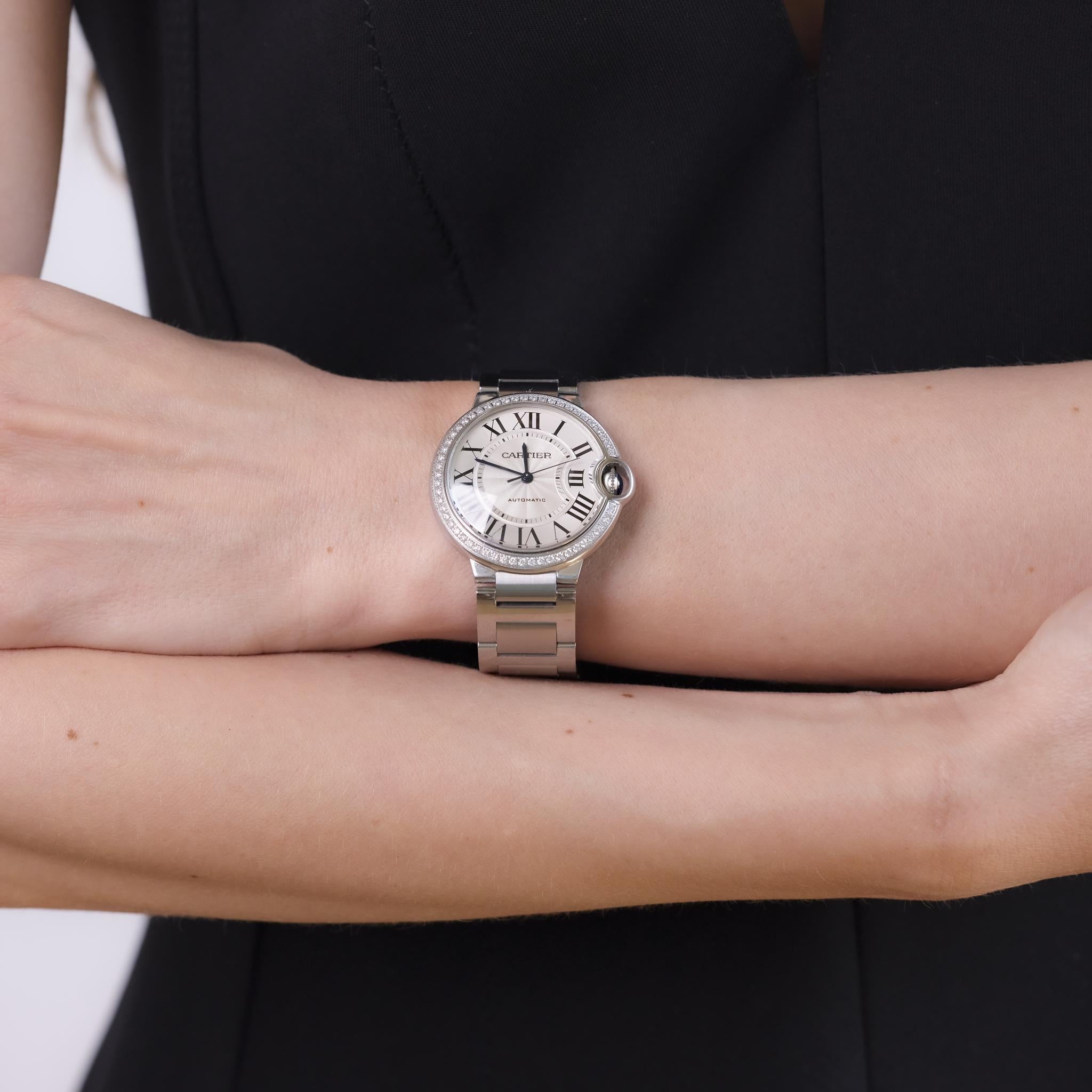 This vintage Cartier mid-size 36mm watch from the 2010s features a bezel set with 54 original round brilliant cut diamonds totaling approximately 0.55 carats, graded D-E color and VS clarity. Powered by an automatic movement and crafted in stainless