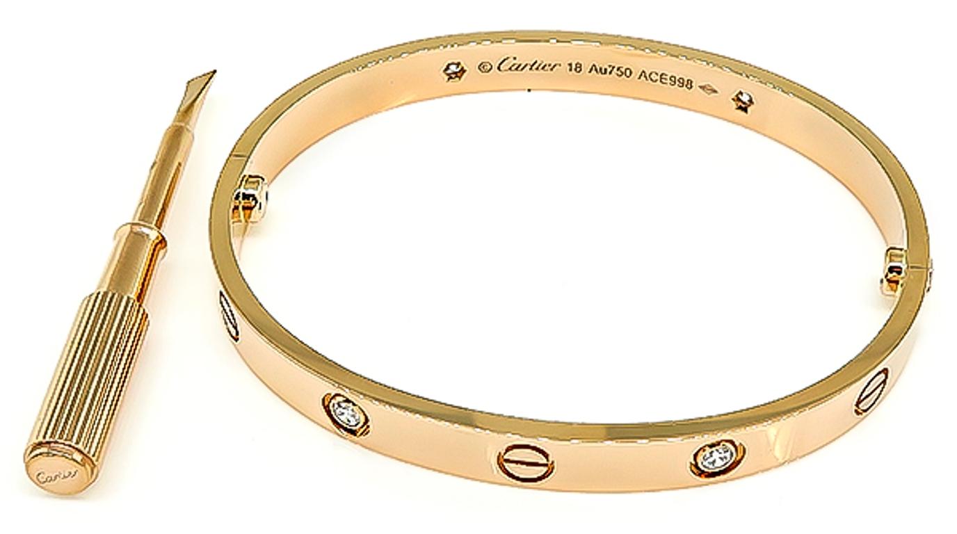 This elegant 18k pink gold love bangle by Cartier is set with 4 sparkling round cut diamonds that weigh approximately 0.40ct. The bangle measures 6mm in width. It is size 18 and weighs 31.7 grams. The bangle is signed Cartier 18 Au750 ACE998 and it