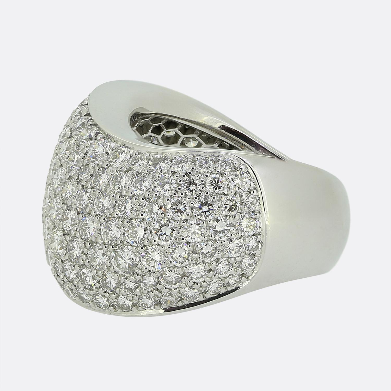 Here we have a spectacular dress ring from the world renowned luxury jewellery house of Cartier. This substantial piece has been crafted from 18ct white gold and showcases an undulating wave form; the face of which has been pavé set with a vast