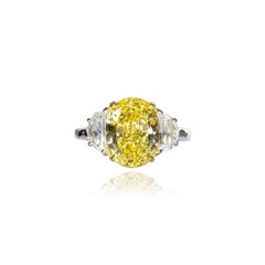 Cartier 6,95 qt Anillo de tres piedras con diamante amarillo intenso de fantasía y talla brillante ovalada