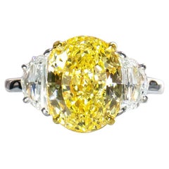 Cartier 6,95 Karat Oval Brillantschliff Ausgefallener intensiv gelber Diamantring mit drei Steinen im Brillantschliff