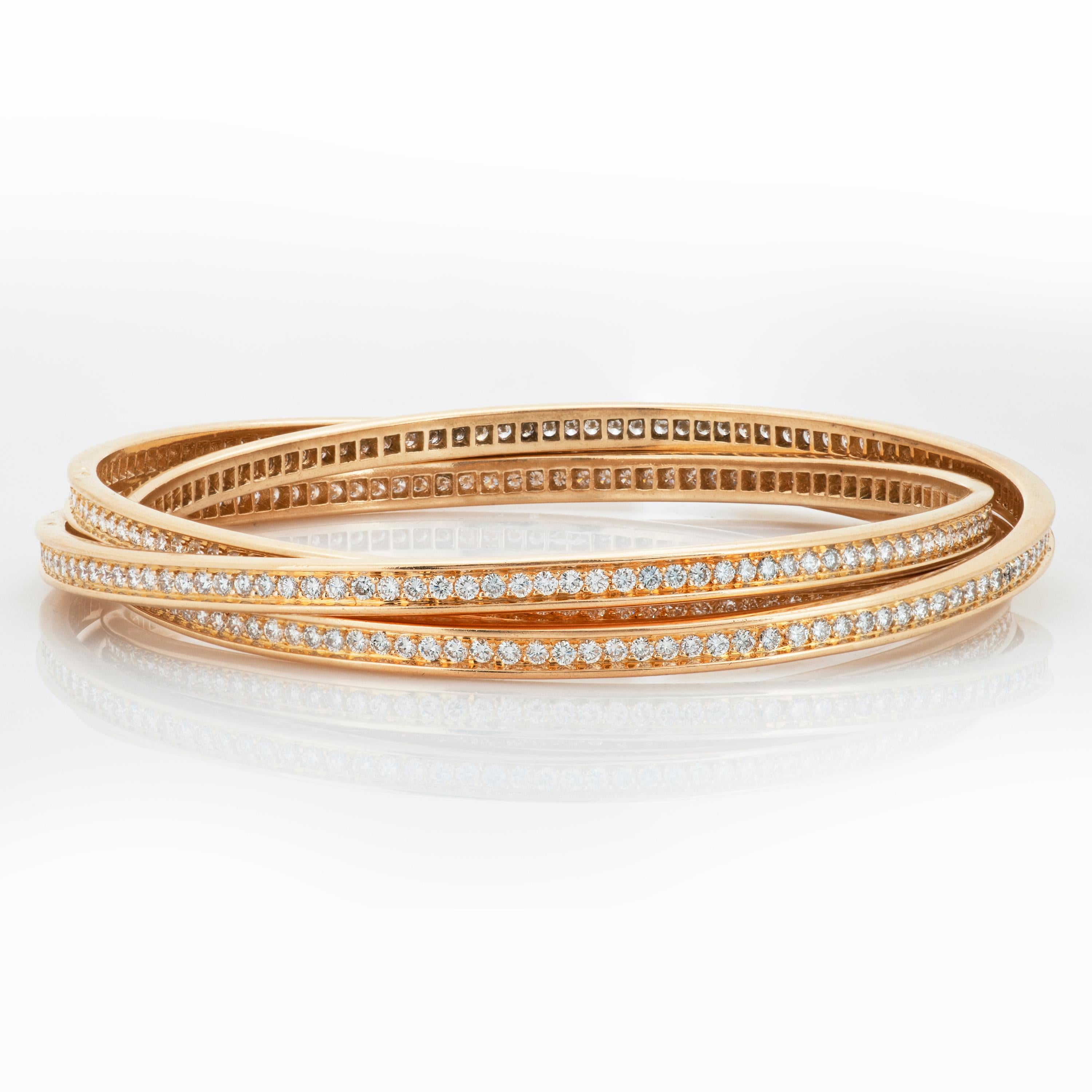 Cartier 18k yellow gold and diamond trinity rolling bangle bracelet with French hallmarks and Cartier box. 

This Cartier trinity bracelet is made up of 3 intertwining bangles set all the way around with round brilliant cut diamonds totaling