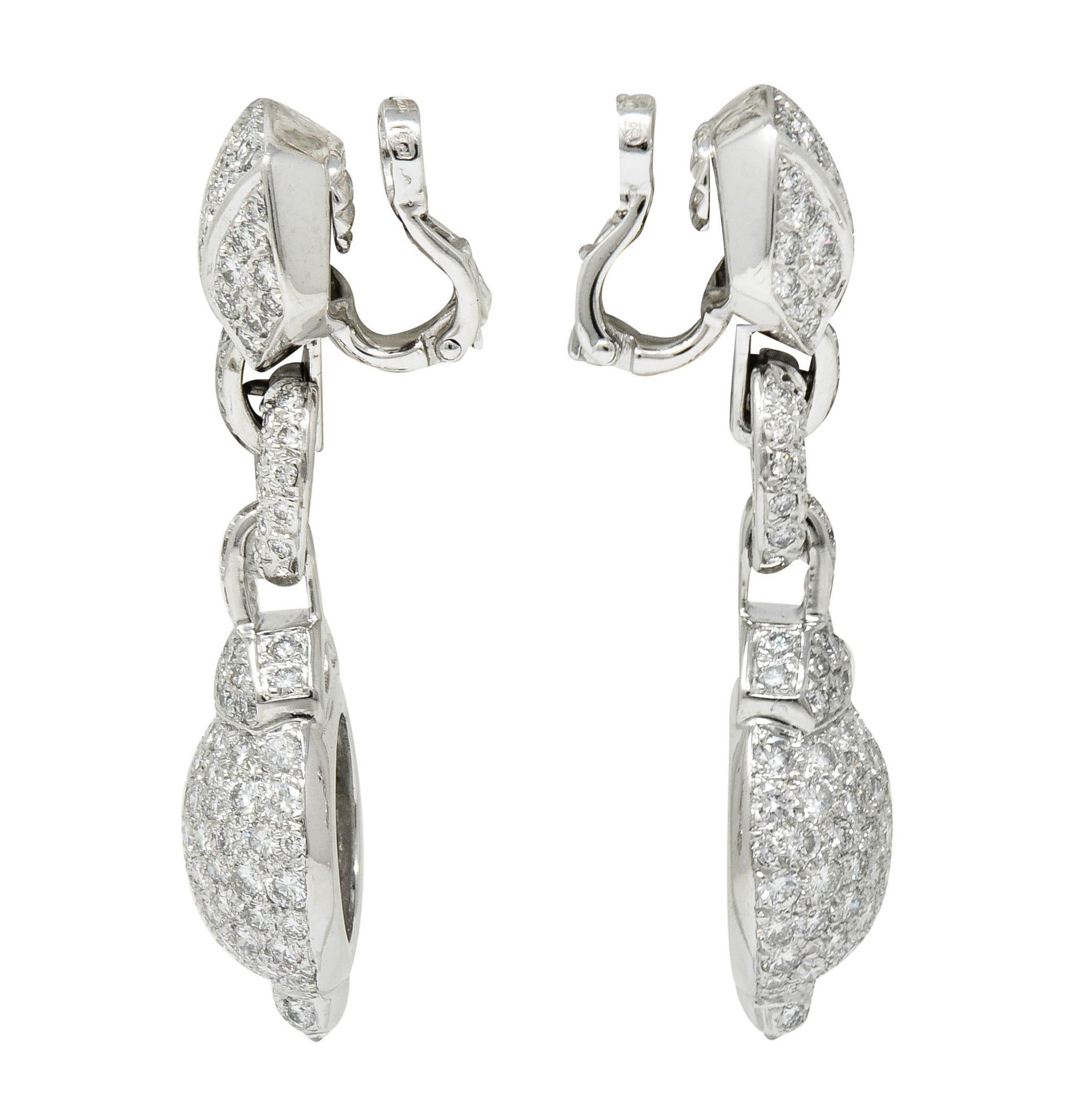 Ear-clip earrings are designed as an articulated linkage motif suspending a bulbed drop

Pavé set throughout by round brilliant cut diamonds weighing in total approximately 7.50 carats; F/G color with VS clarity

Completed by hinged backs

Numbered