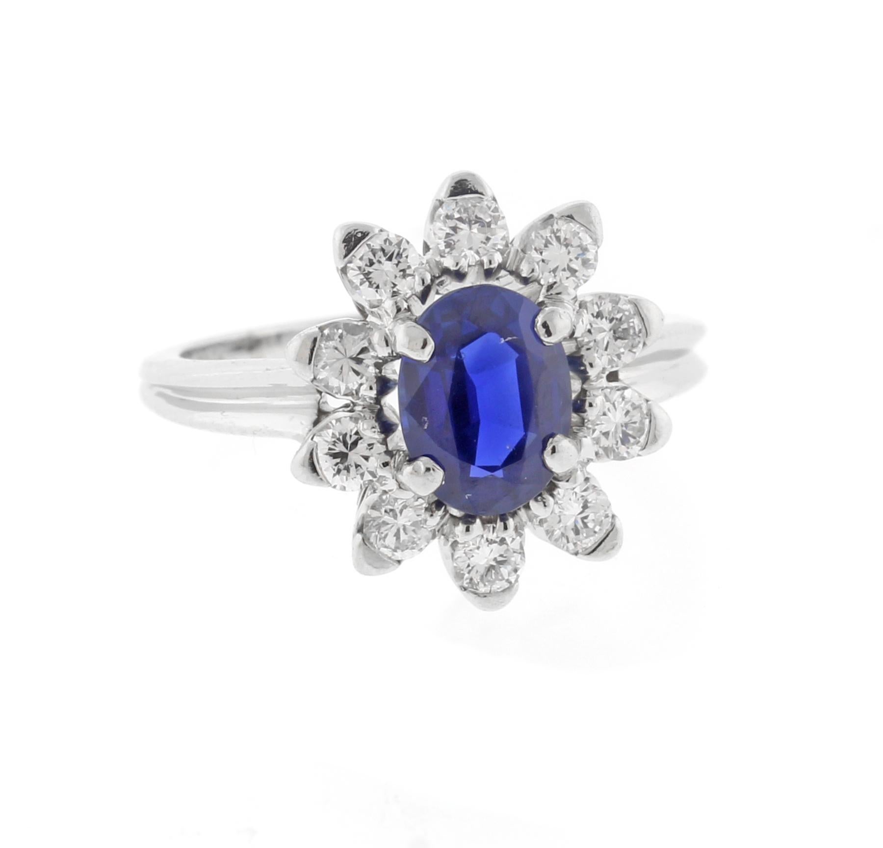 From Cartier, a classic diamond cluster ring
♦ Designer: Cartier
♦ Metal: Platinum
♦ Circa 1948, date engraved inside
♦ Sapphire= 1.10 carats, A.G.L. certified non heated, Thailand 
♦ 10 Diamonds=.30ct
♦ Packaging: Pampillonia presentation box
♦