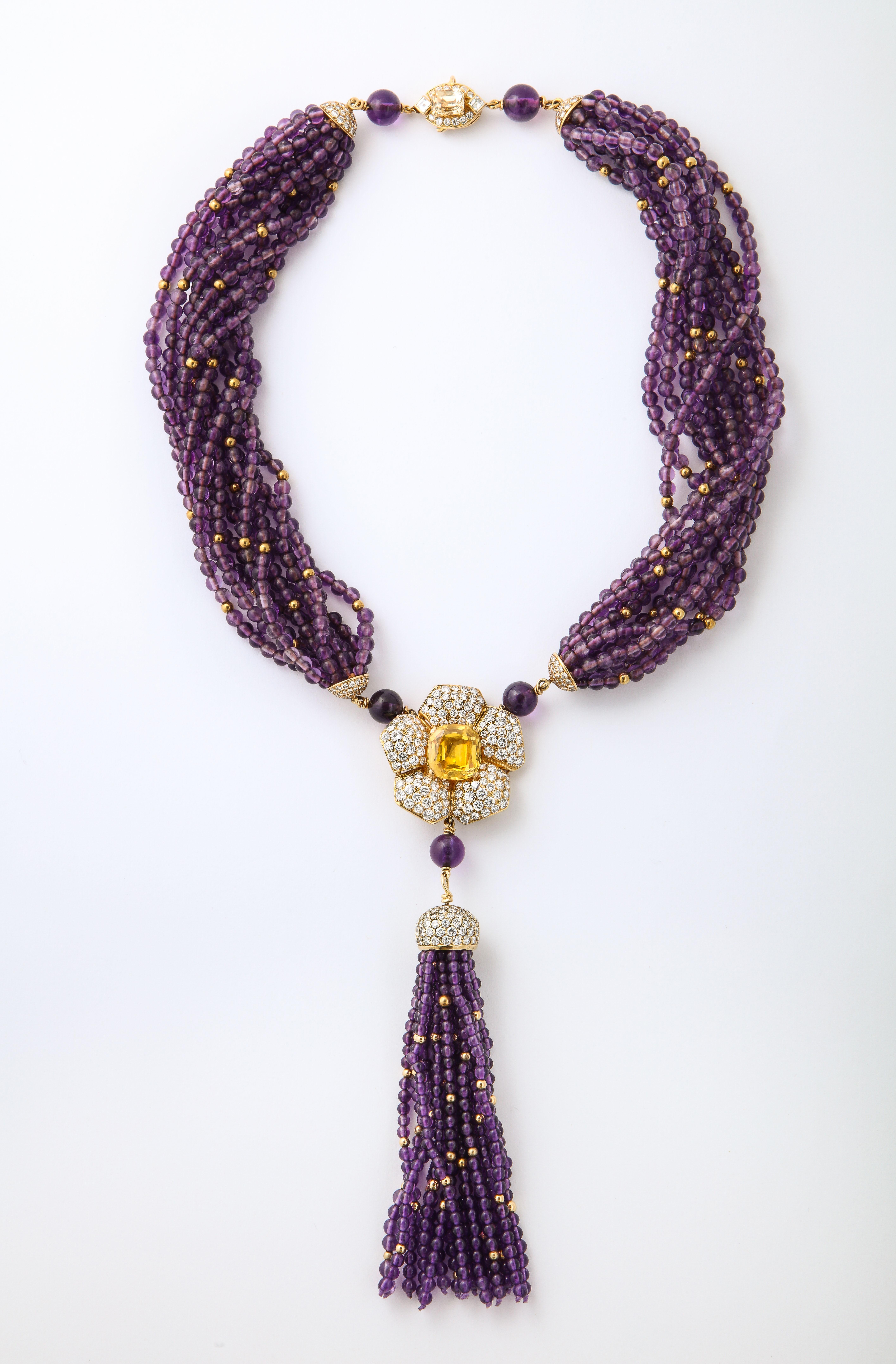 Custom designed amethyst torsade necklace with a detachable tassel pendant.  The center stone in the pendant is a 12.24 carat cushion cut yellow sapphire that is certified by The American Gemological Laboratory to be without any heat treatment and