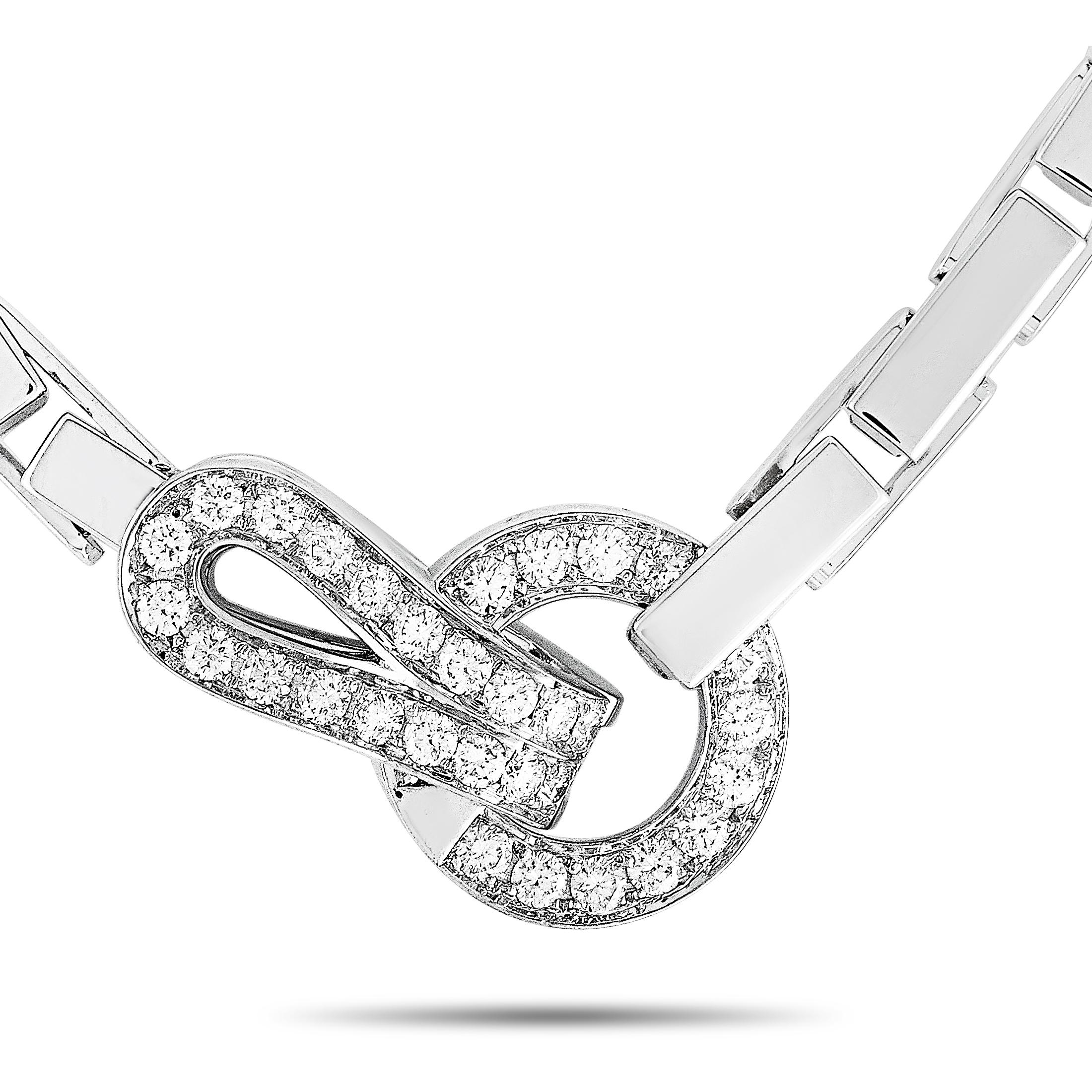 The Cartier “Agrafe” necklace is crafted from 18K white gold and weighs 62.2 grams. It is presented with a 15” chain and a pendant that measures 0.90” in length and 0.60” in width. The necklace is embellished with diamonds that boast grade E color