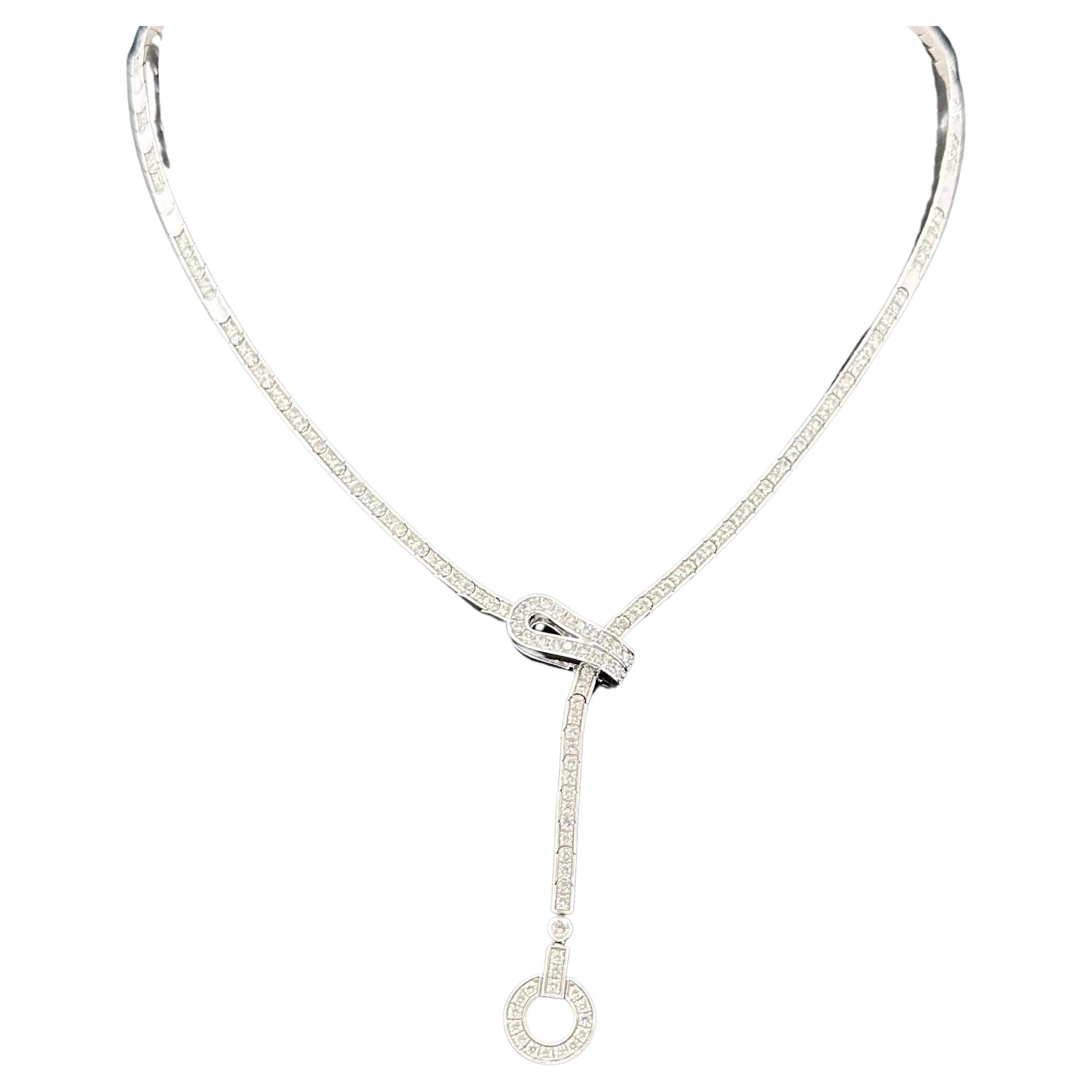 Cartier Agrafe Collection Necklace circa 2010 Inspired by the Hook, and Eye Corset Fastening. Agrafe is a Cartier classic
French Hand Made with 18k White Gold Set - 150 round Diamonds in a lariat style necklace. 
Diamond Weight 3.75 cts
The length