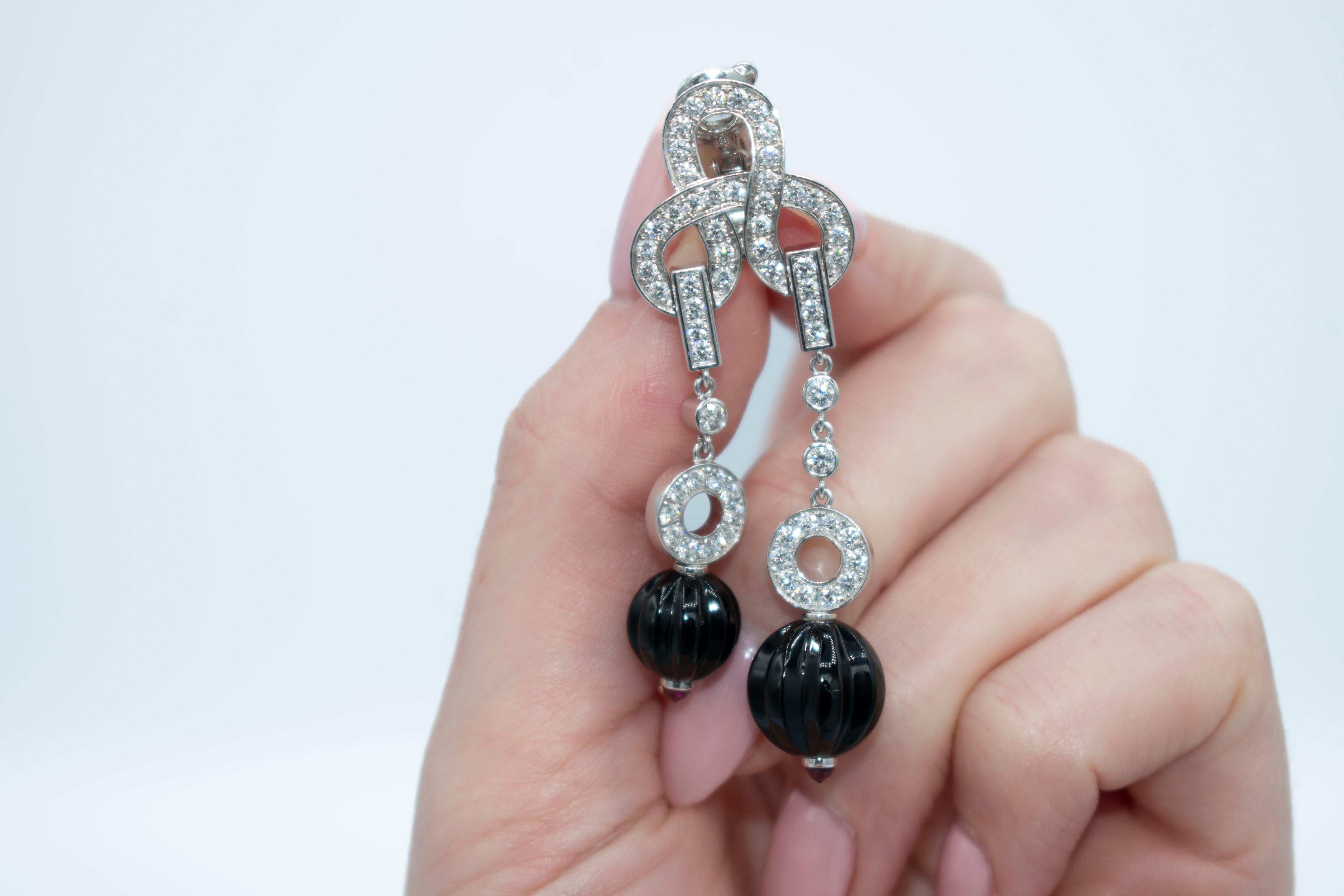 The Agrafe collection from Cartier focuses on a motif that was inspired from the clasps of Parisian corsets. The motif, taken from Haute Couture, is translated with creativity into varied forms of fine jewelry. These earrings, designed in a lovely