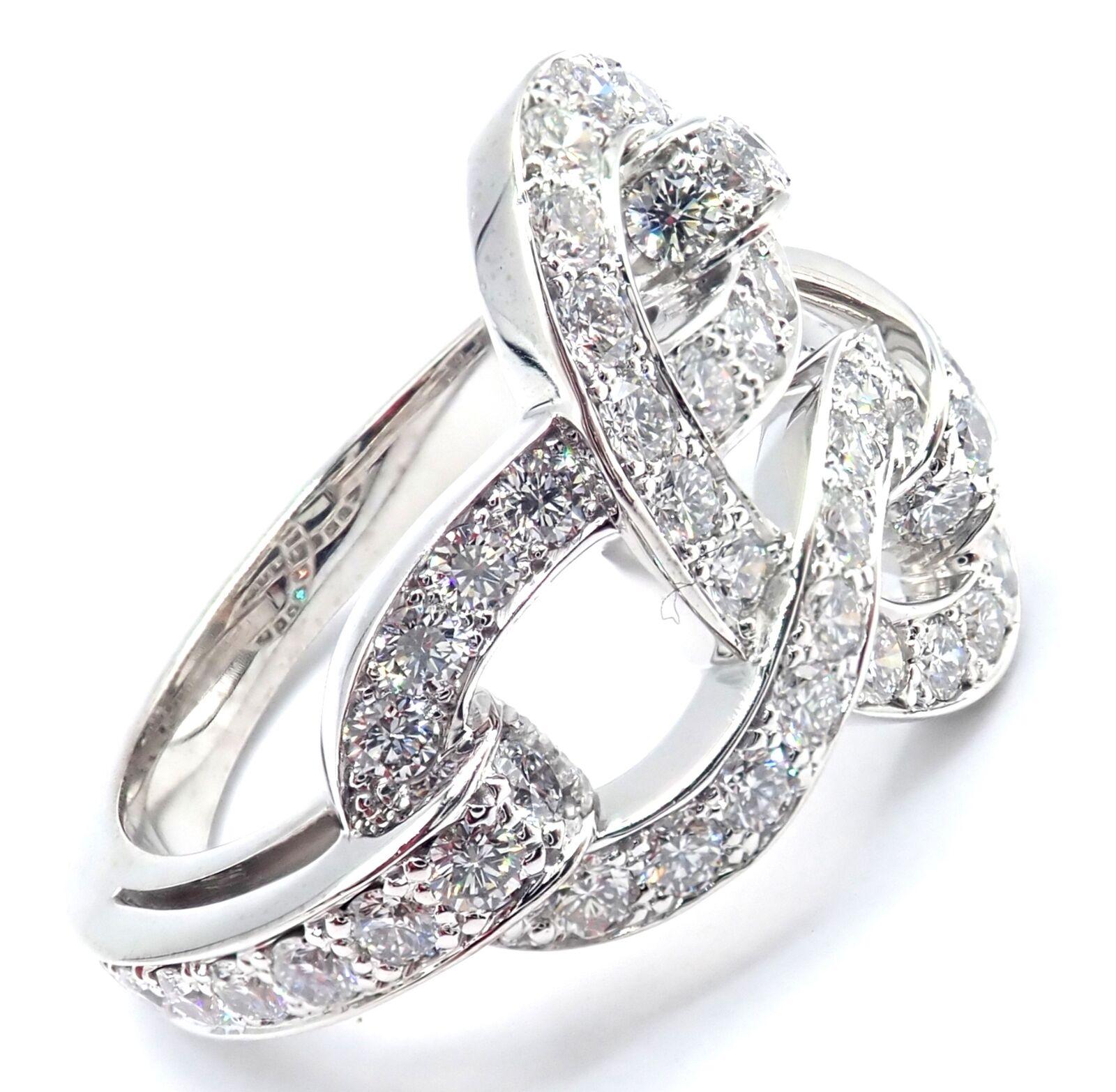 18k White Gold Diamond Agrafe Band Ring by Cartier.
With Round Brilliant Cut Diamonds VVS1 clarity, E color total weight approximately 1.23ct
Details:
Size: European 51, US 5 3/4
Weight: 9.4 grams
Stamped Hallmarks: Cartier 750 51 898XXX(serial