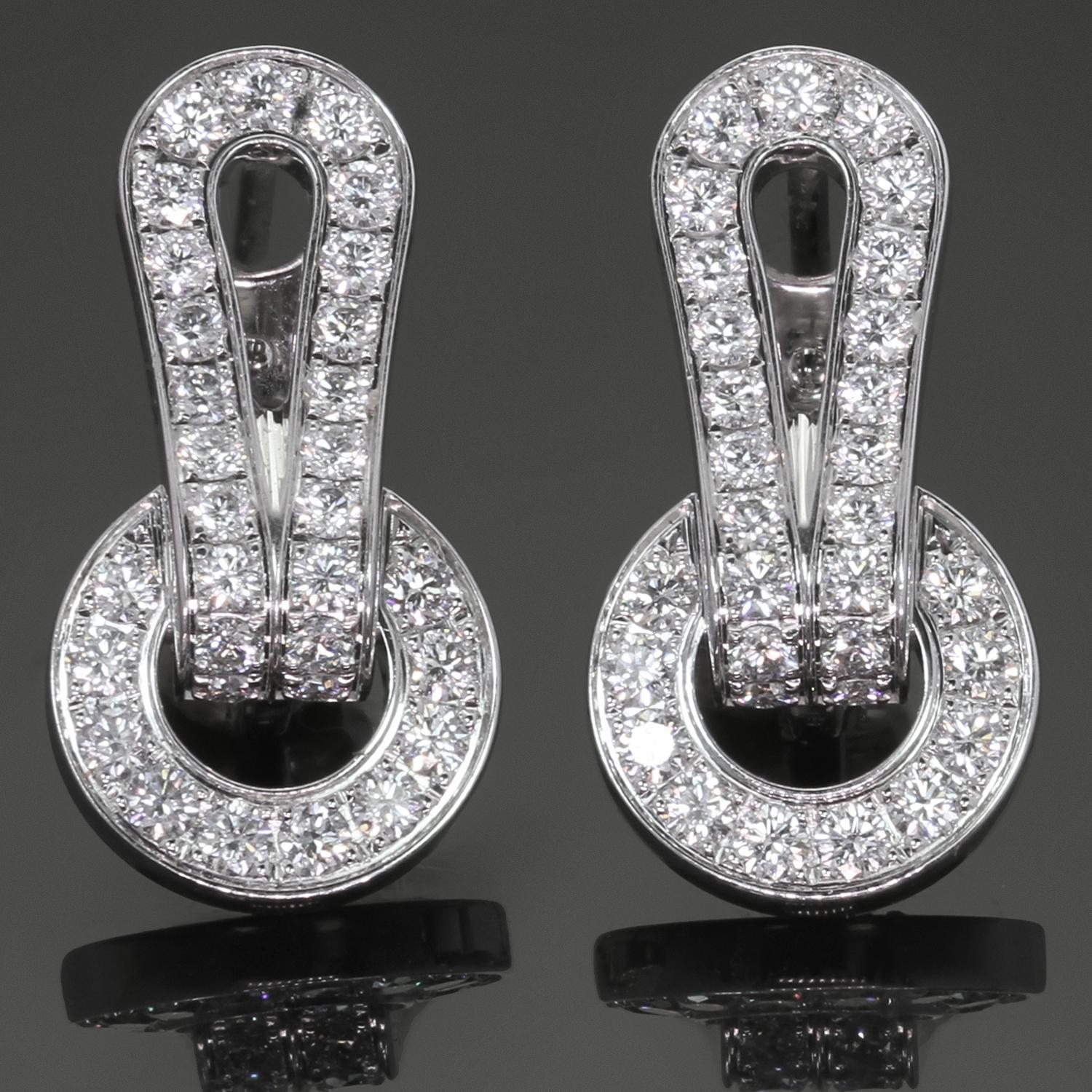 These gorgeous Cartier earrings from the classic Agrafe collection is crafted in 18k white gold and set with about 52 brilliant-cut round diamonds. Made in France circa 2000s. Measurements: 0.43