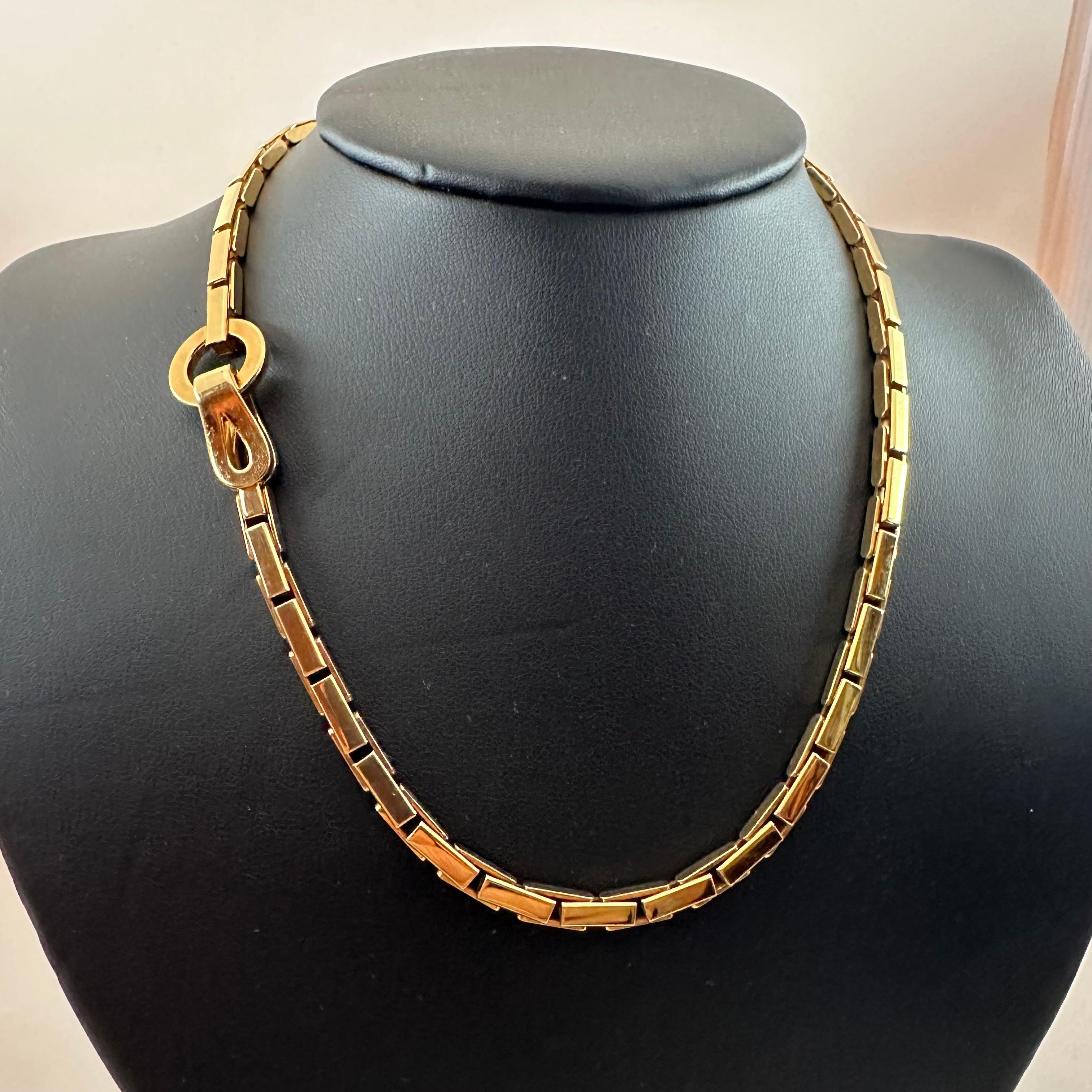 Cartier’s Agrafe Collection Necklace made in 18k yellow gold. Agrafe is based on a unique clasp, consisting of a circle and hook This one is 17 inches long and 67 grams of 18k Yellow Gold. Stamped Cartier and numbered.  Circa 2000