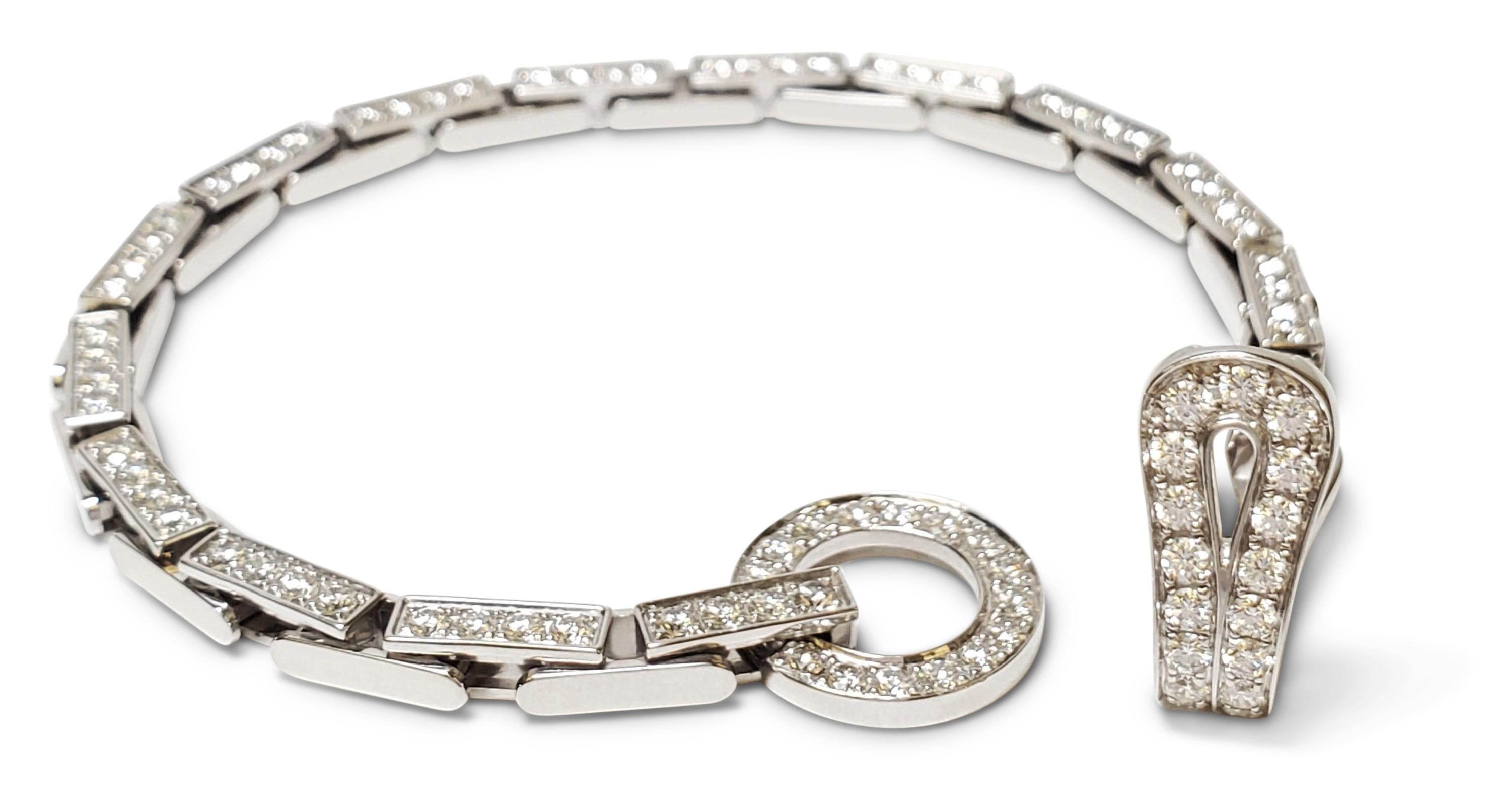 Authentic Cartier Agrafe bracelet comprised of brickwork links and completed with hook and eye closure. Both the clasp and links are set with a total of approx. 3.25 carats of round brilliant cut diamonds (E-F color, VS clarity). Signed Cartier,