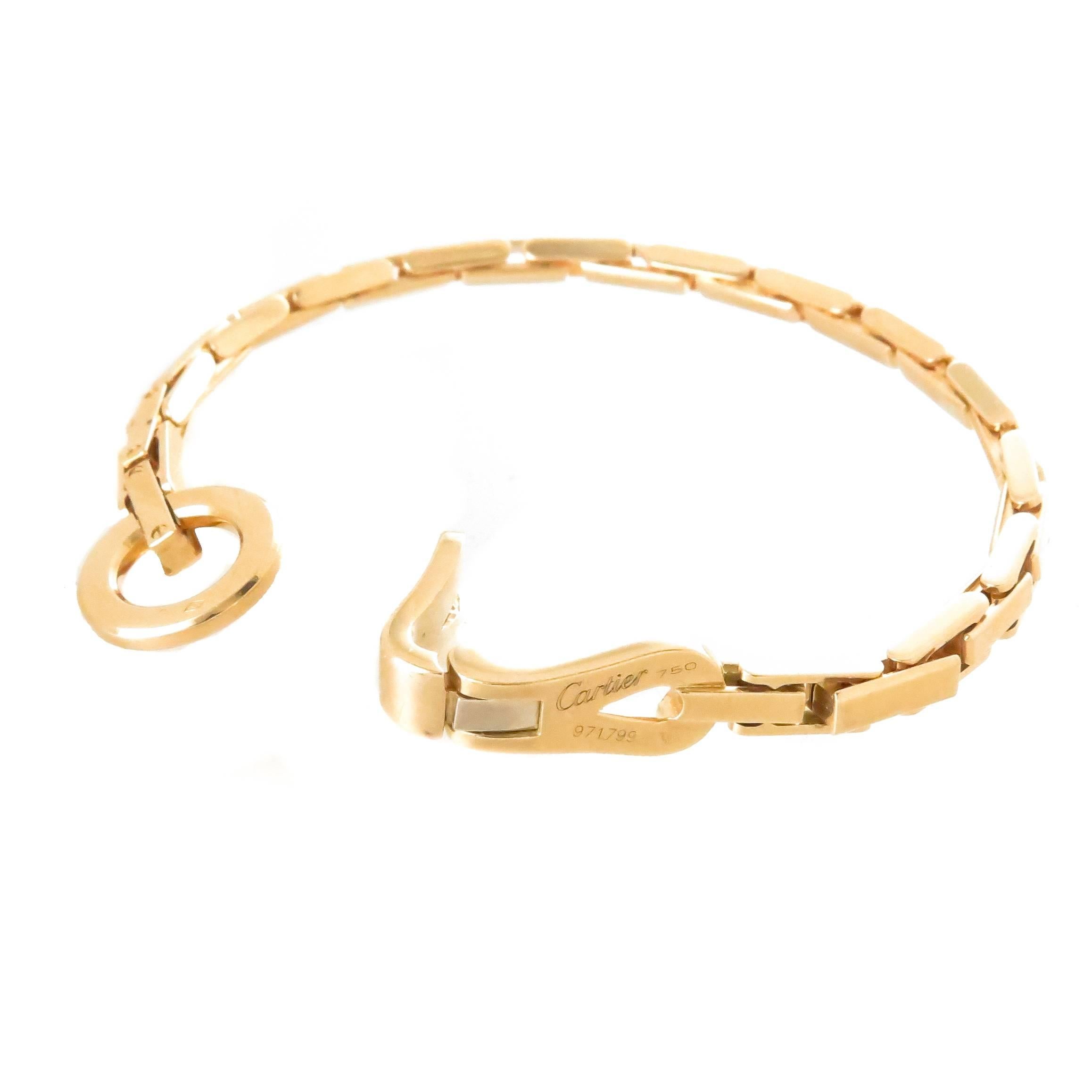 Circa 2010  Cartier Agrafe collection 18K yellow Gold bracelet, measuring 7 1/2 inches in length and 3/16 inch wide. Comprising interlocking elongated box links. Comes in the original Cartier presentation box.