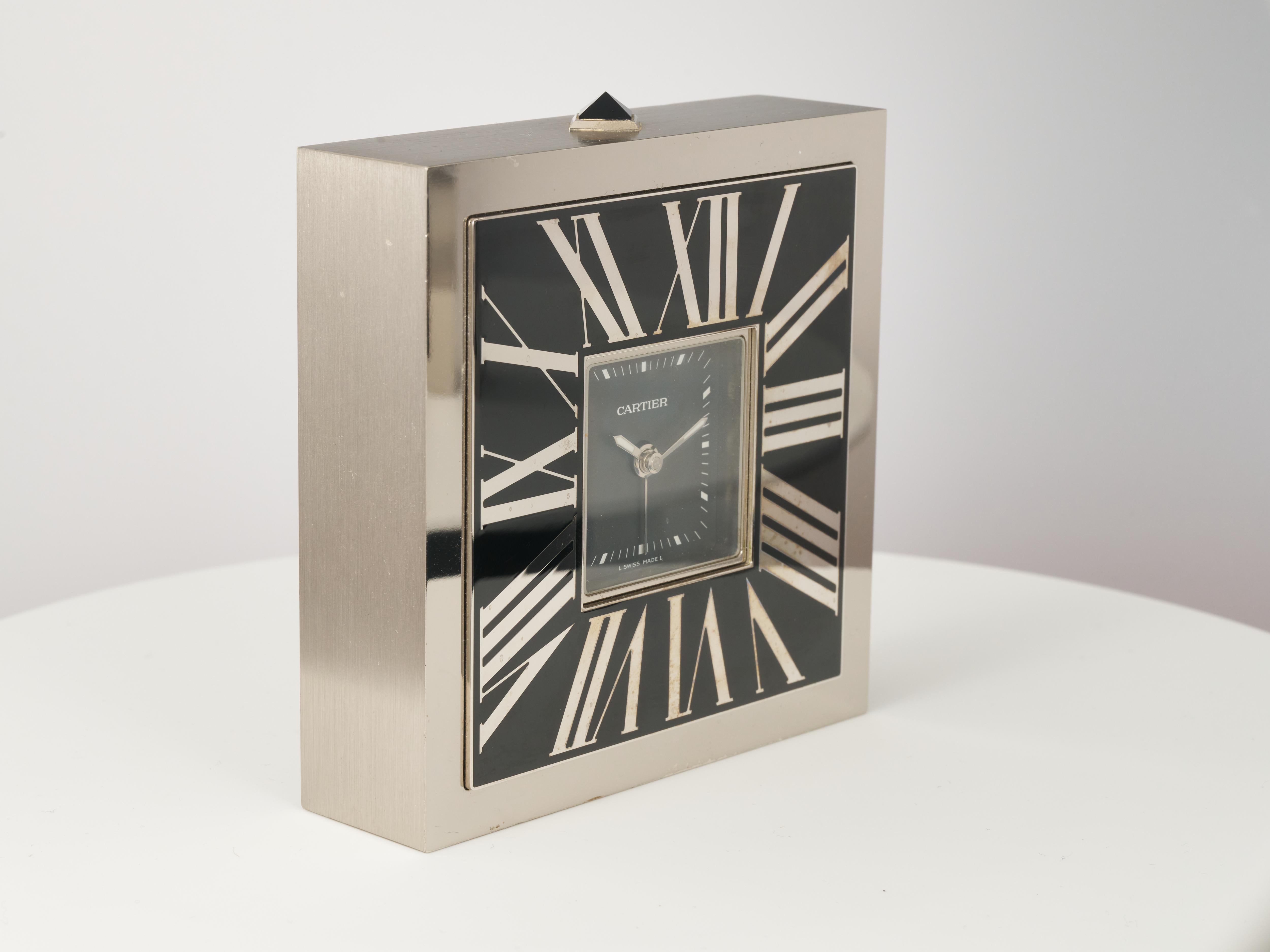 Fork In Time is proud to offer on the 1st Dibs marketplace:

Cartier 
Limited Edition
One of 888
Asian Market Release

Desk Clock with Alarm 

Black Dial with Batton Indices + Reverse Enameled Roman Numerals on Case

Polished Stainless Steel Front