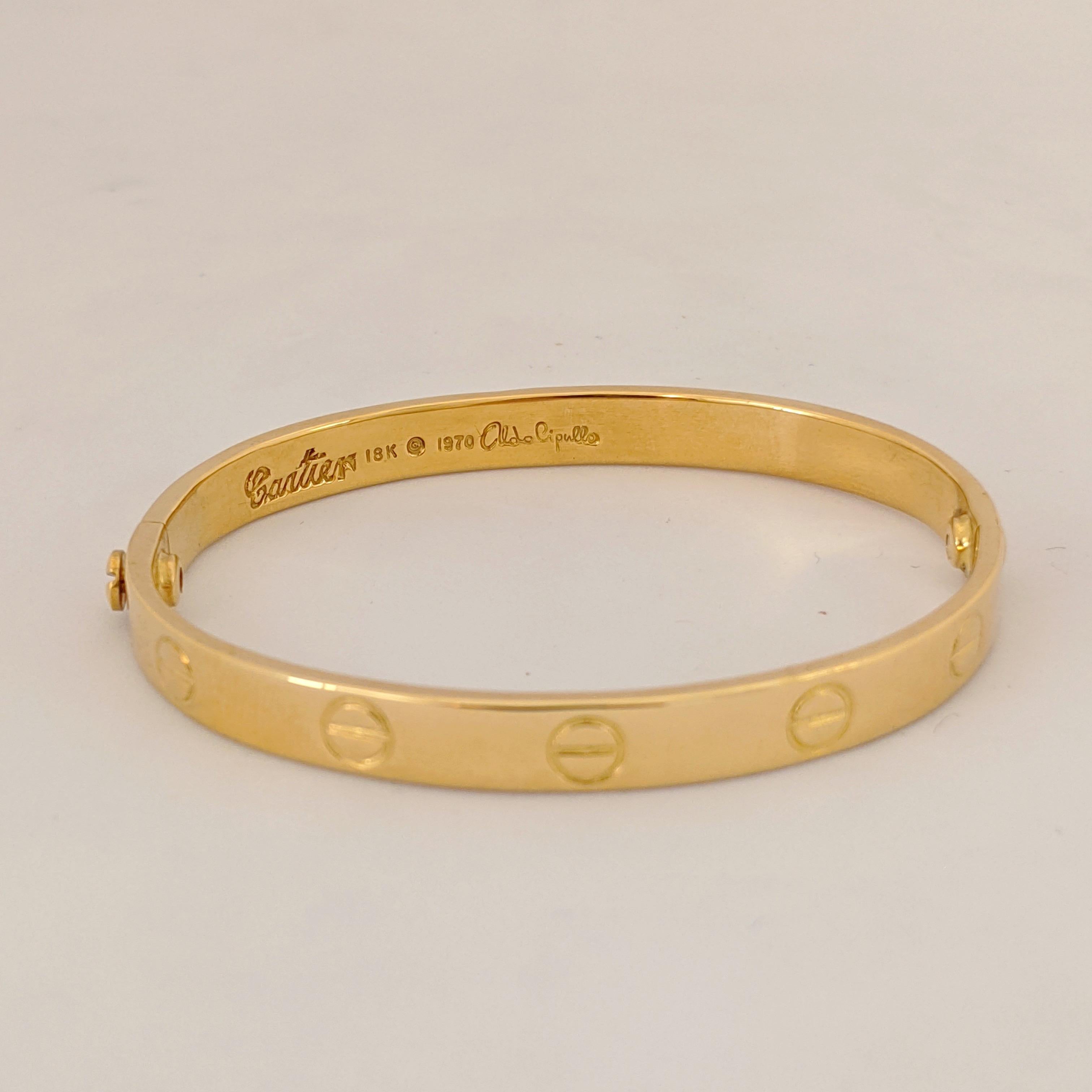 Designed in 1970 by Aldo Cipullo ... The Cartier Love bracelet is known to be one of the most iconic bracelets ever designed. 
The inside measurement of this bracelet measures 52mm across and 43 mm high.
Signed Cartier 18K 750 signed Aldo