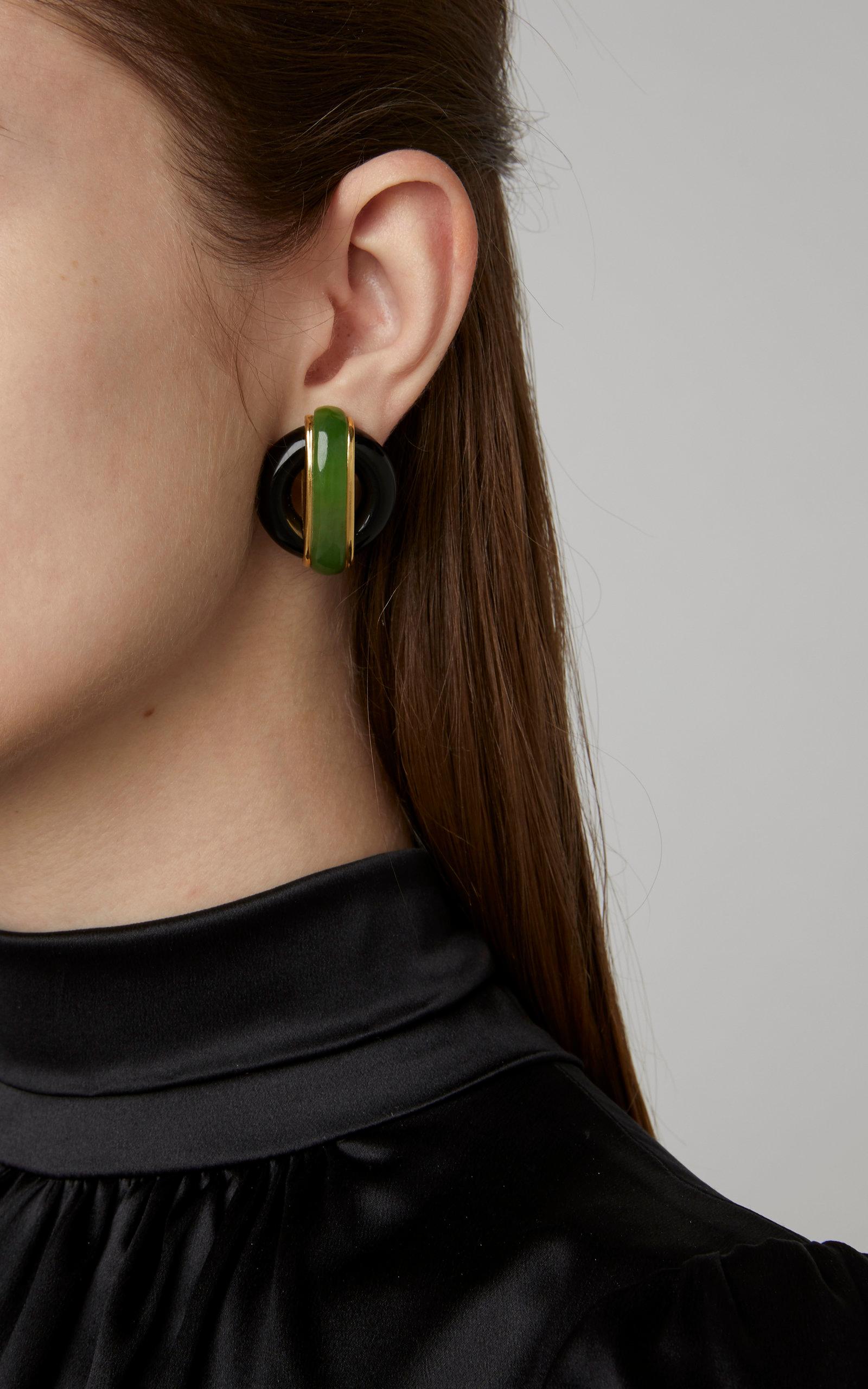A pair of iconic Cartier ear-clips designed by esteemed Italian designer Aldo Cipullo, with jade and onyx, mounted on 18kt yellow gold. Dated 1972.