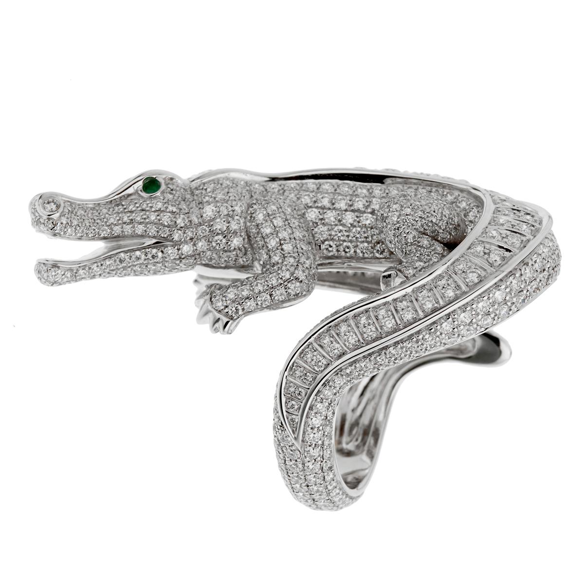 A magnificent diamond and emerald alligator ring by Cartier, the ring is set with 5.45ct of the finest Cartier diamonds which are pave set. The eyes are set with circular-cut emeralds mounted in platinum. The ring measures a size 54 / us 6 1/2