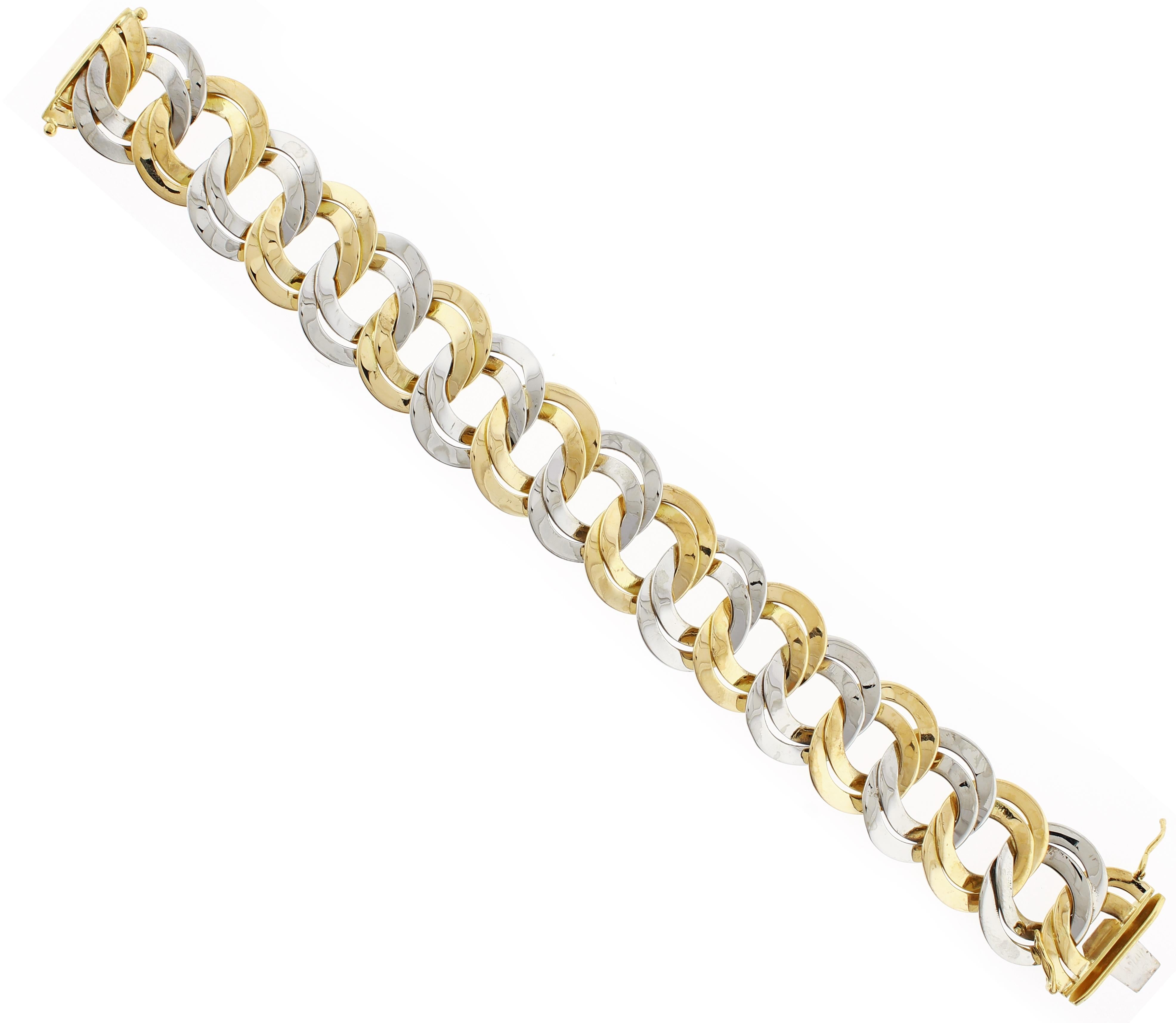 
From Cartier, a bold bracelet comprised of alternating white and yellow flat 18 karat links
♦ Designer: Cartier
♦ Metal: 18 karat
♦ Circa 1980s
♦ 7 5/8ths of and inch  long 8/8ths wide
♦ 58.8 grams
♦ Packaging: Pampillonia presentation box 
♦