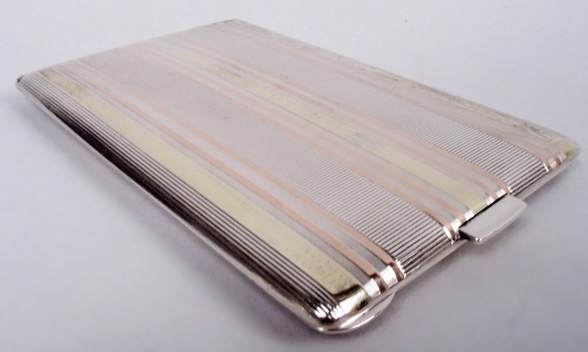 American Art Deco sterling silver and 14k gold cigarette case, ca 1920. Retailed by Cartier in New York. Rectangular and hinged with push tab. Front and back have horizontal linear pattern comprising pink and yellow gold stripes and silver stripes
