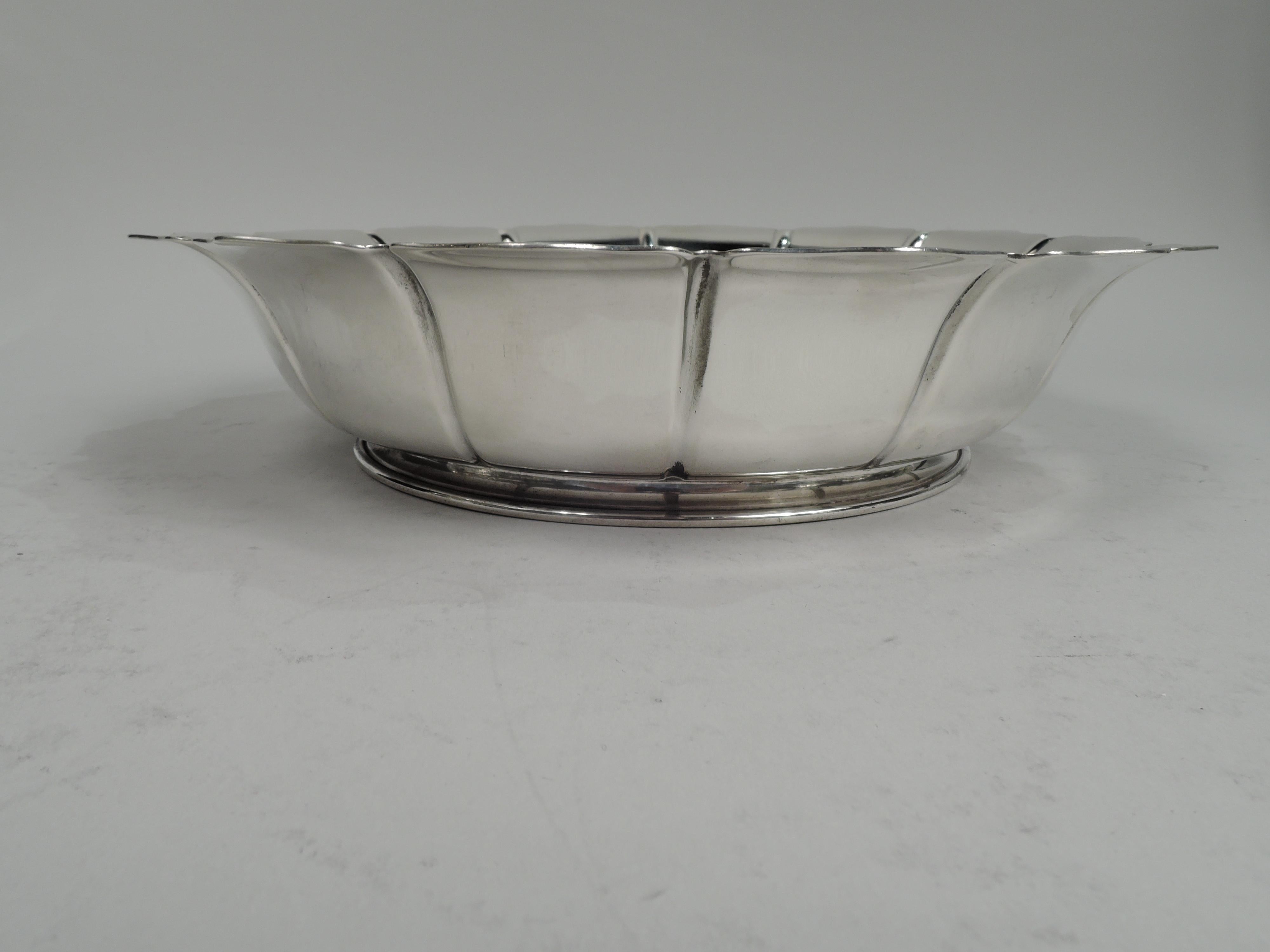 American Art Deco sterling silver bowl, ca 1930. Retailed by Cartier in New York. Round well and incised petal sides with scrolled rim. Short and spread foot. Fully marked including retailer’s stamp and no. 869. Weight: 12.5 troy ounces.