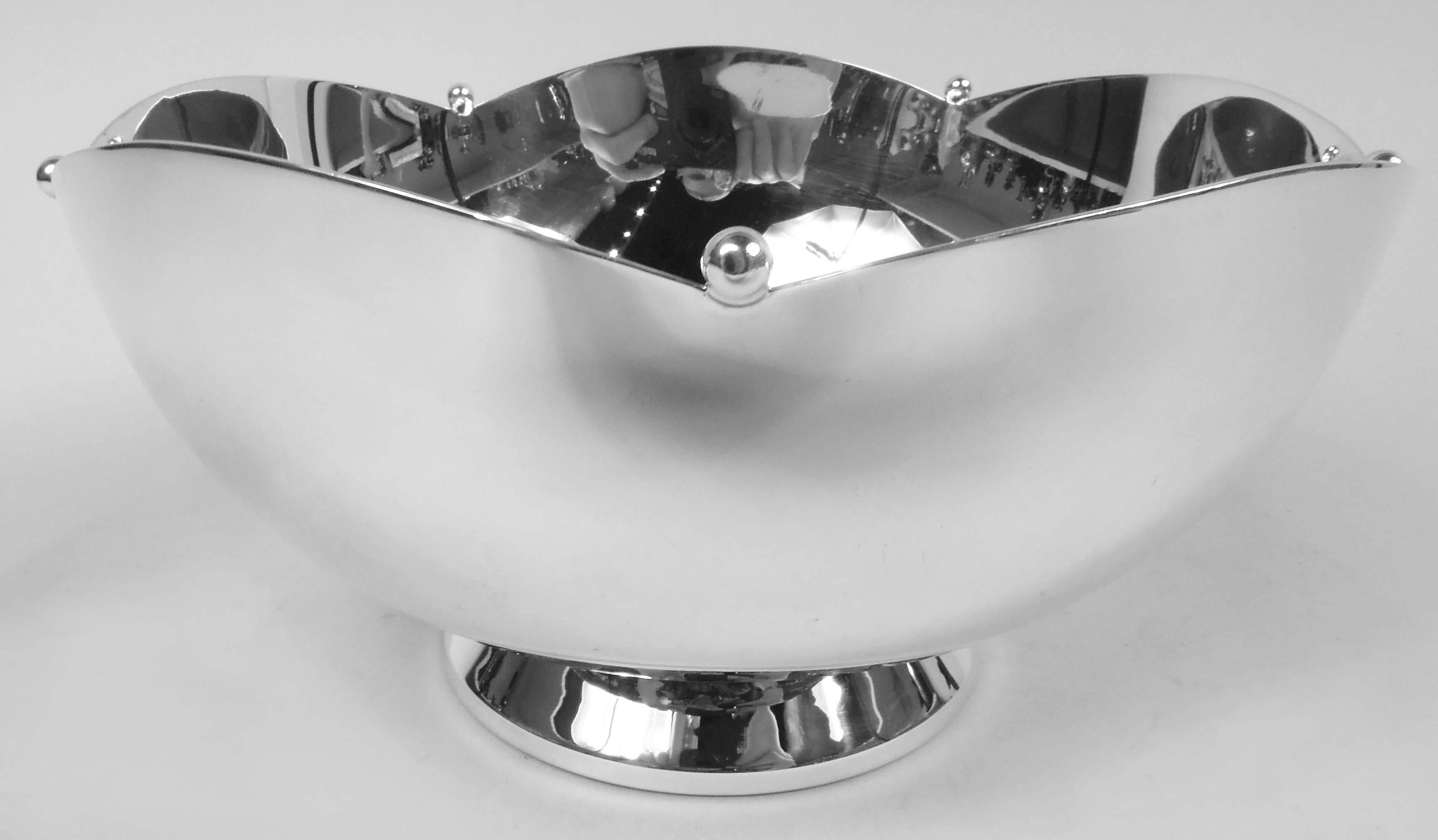 Art Deco sterling silver bowl. Made by Currier & Roby in New York, ca 1930. Curved sides and raised and spread foot; mouth rim has wide scallops with applied beads. Fully marked including maker’s and retailer’s (Cartier) stamps and no. 608. Weight: