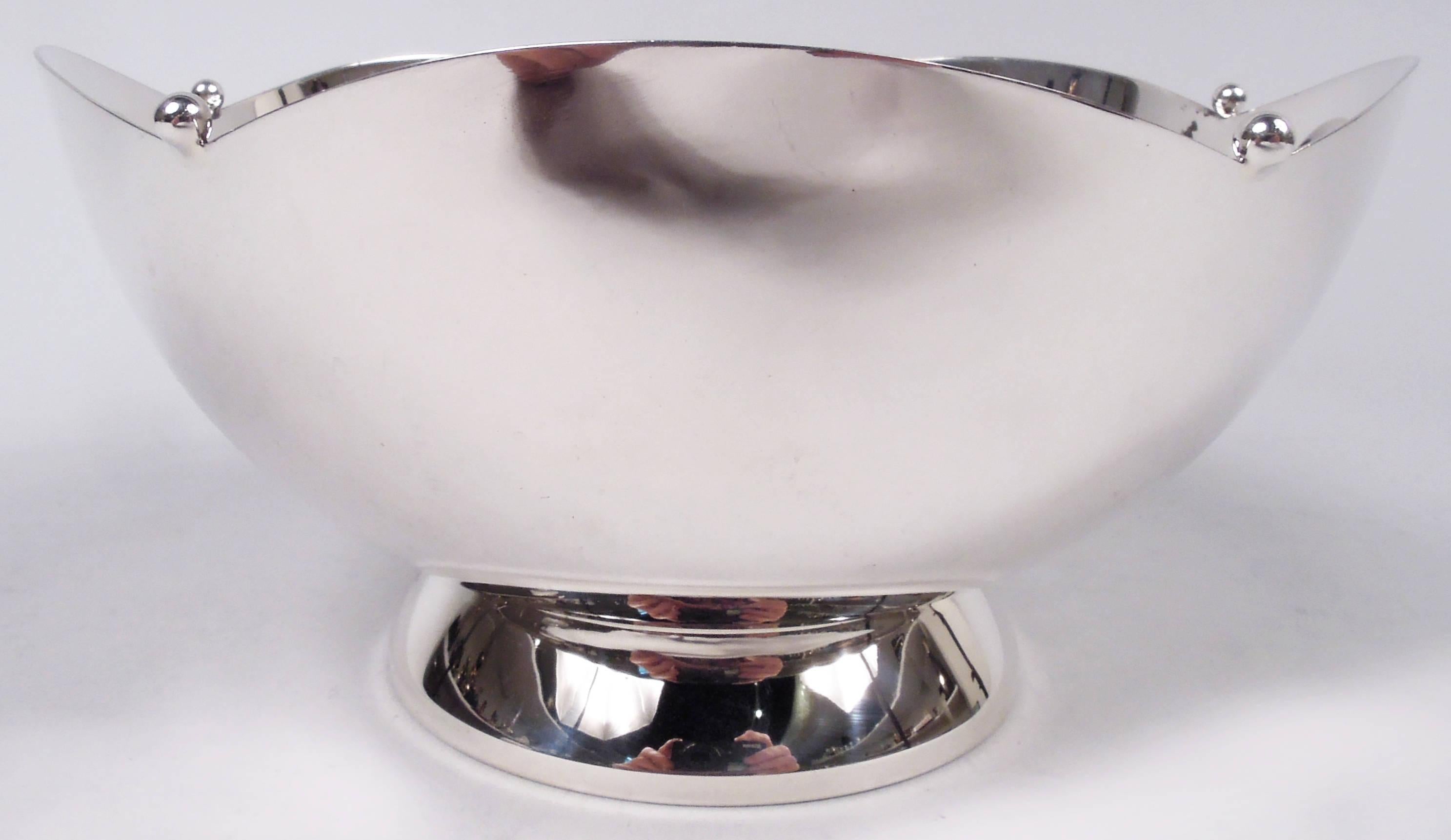 Art Deco sterling silver bowl. Made by Currier & Roby in New York, ca 1930. Curved sides and raised and spread foot; mouth rim has wide scallops with applied beads. Fully marked including maker’s and retailer’s (Cartier) stamps and no. 606. Weight: