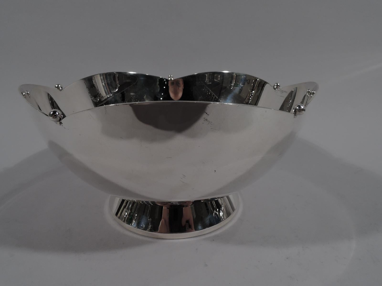 Art Deco sterling silver petal bowl. Retailed by Cartier in New York, circa 1930. Curved sides and petal rim interspersed with beads. Raised and spread foot. Fully marked including no. 606 and maker’s and retailer’s stamps. The maker was Currier &