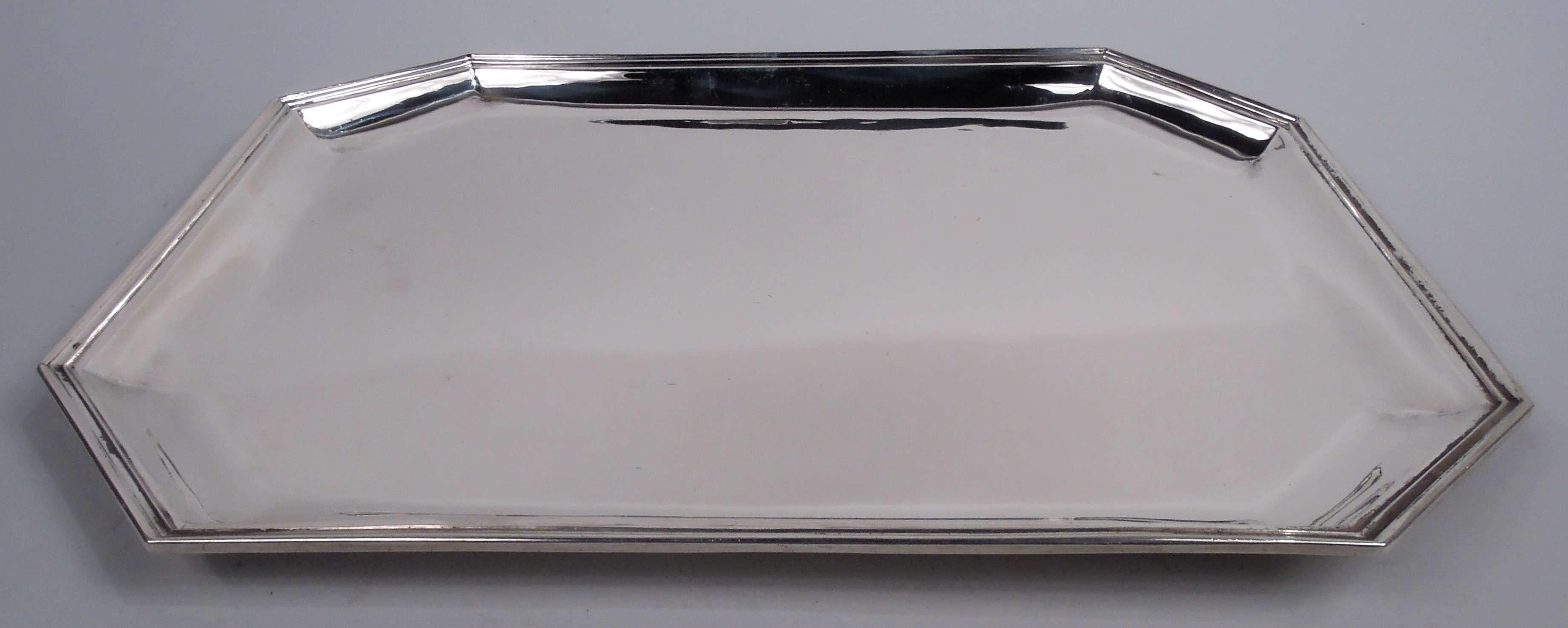 American Art Deco sterling silver tray, ca 1925. Retailed by Cartier in New York. Rectangular with chamfered corners, tapering sides, and molded rim. Fully marked including retailer’s stamp, no. 25/4, and phrase “Hand Made”. Weight: 23.8 troy ounces.