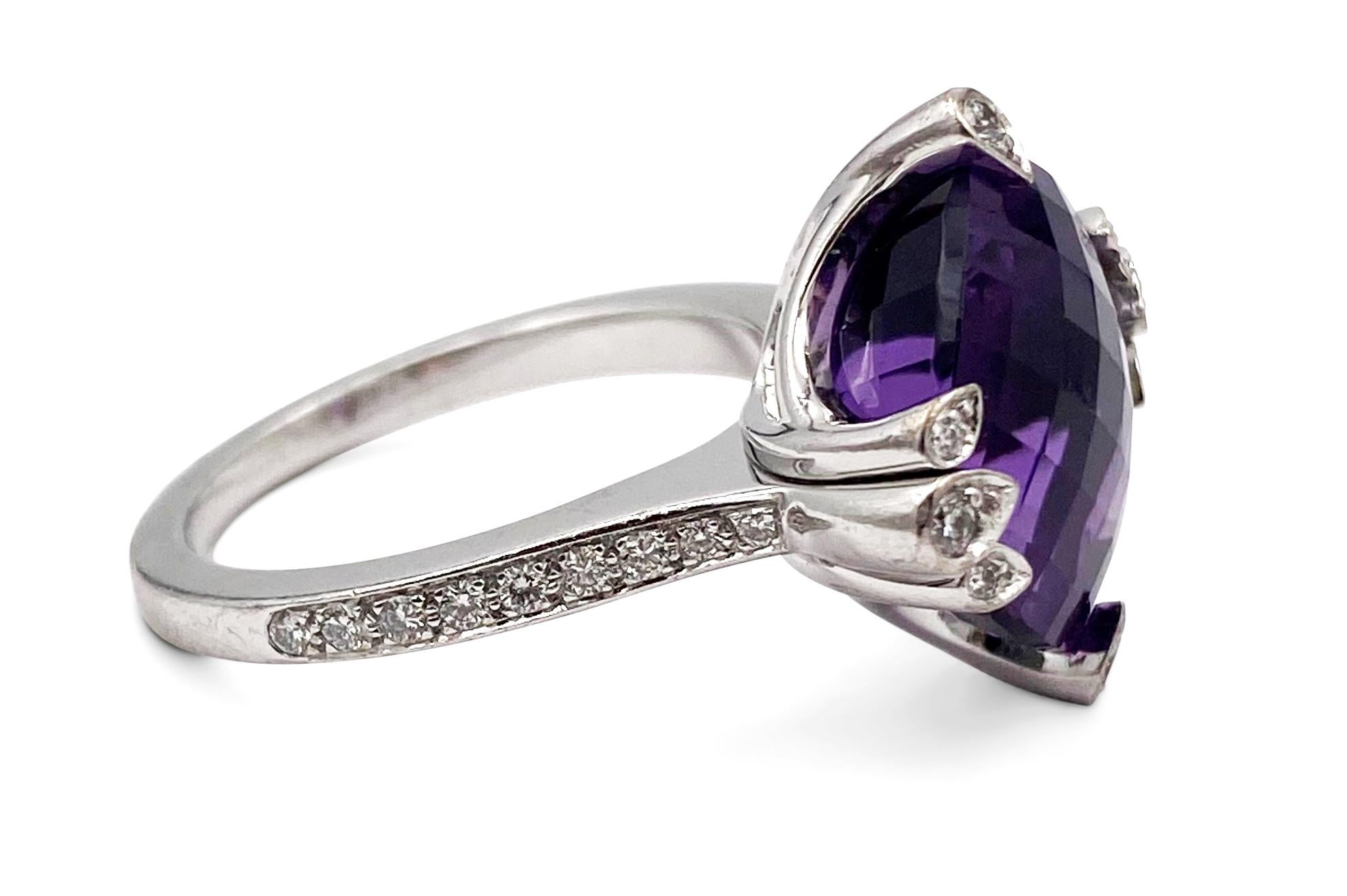 Authentic Cartier Lotus ring made in 18 karat white gold with approximately 26 round cut diamonds and a faceted amethyst center.  Size 51, CIRCA 2009.  Stamped Cartier, 750, 51.  Ring is accompanied by original Cartier box and receipt
