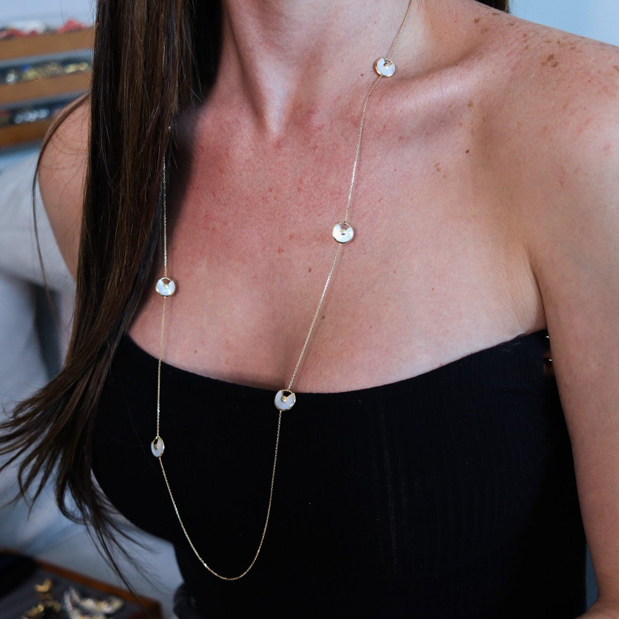 Amulet necklace-sautoir designed by Cartier.

This is the very scarce and desirable Amulets de Cartier necklace sautoir, created in Paris France by the jewelry house of Cartier. The sautoir has been crafted as a station chain in solid yellow gold of