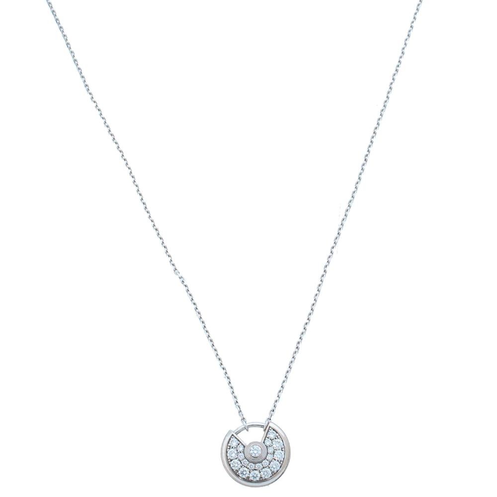 A magnificent offering from Cartier's Amulette de Cartier line. The necklace comes crafted using 18k white gold and it has the signature motif skillfully detailed with shimmering diamonds weighing approximately 0.25 carats. Smoothly finished, the