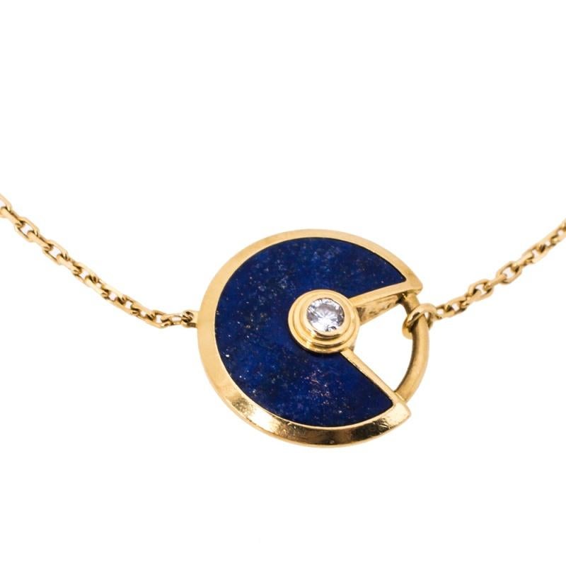 A magnificent offering from Cartier's Amulette de Cartier line. The bracelet comes sculpted from 18k yellow gold and it has the signature motif in Lapis Lazuli highlighted by a shimmering diamond. Smoothly finished, the desirable creation deserves