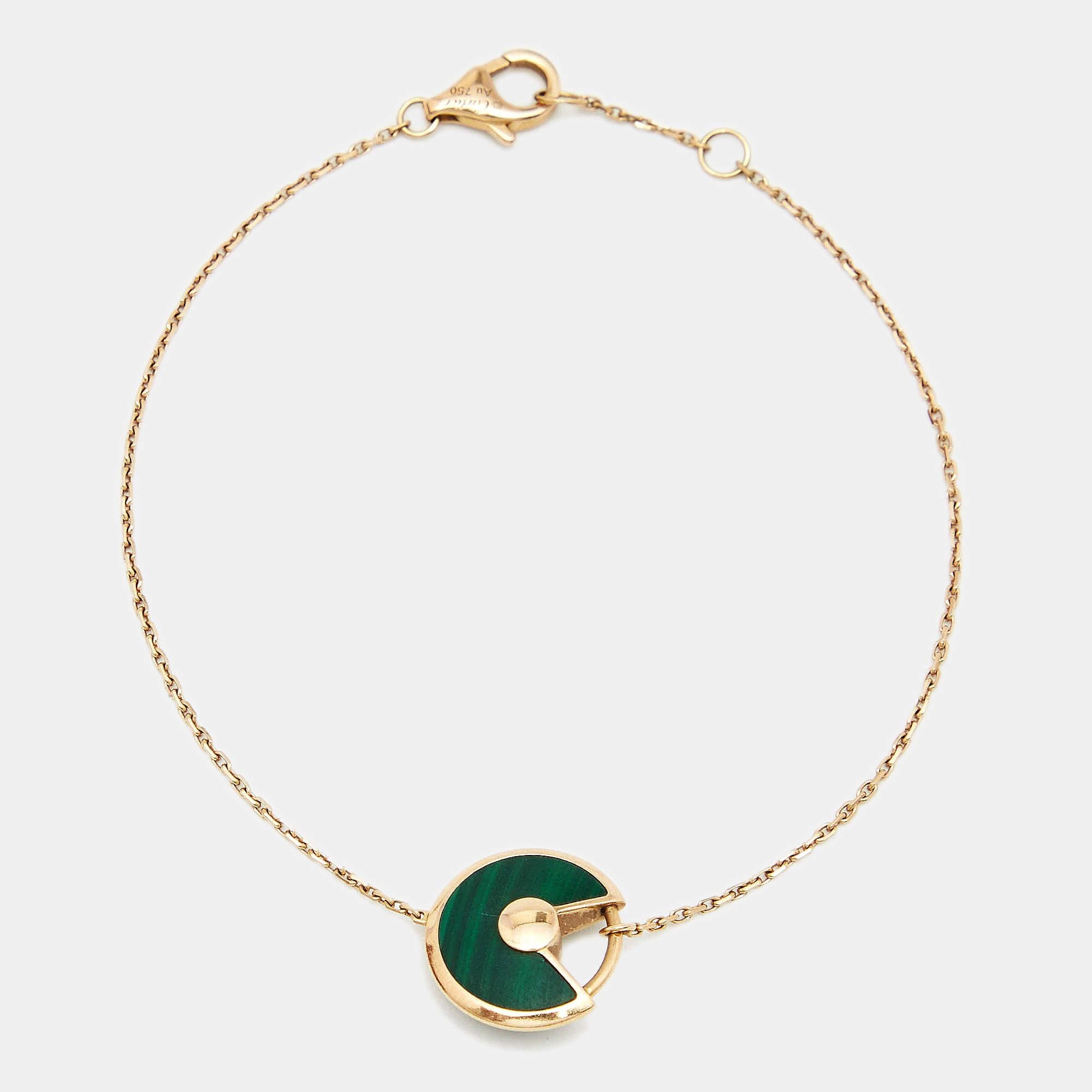 A minimal yet magnificent offering from Cartier's Amulette de Cartier line. The bracelet comes sculpted in 18k rose gold and it has the signature motif in malachite highlighted by a shimmering diamond. Smoothly finished, the desirable creation